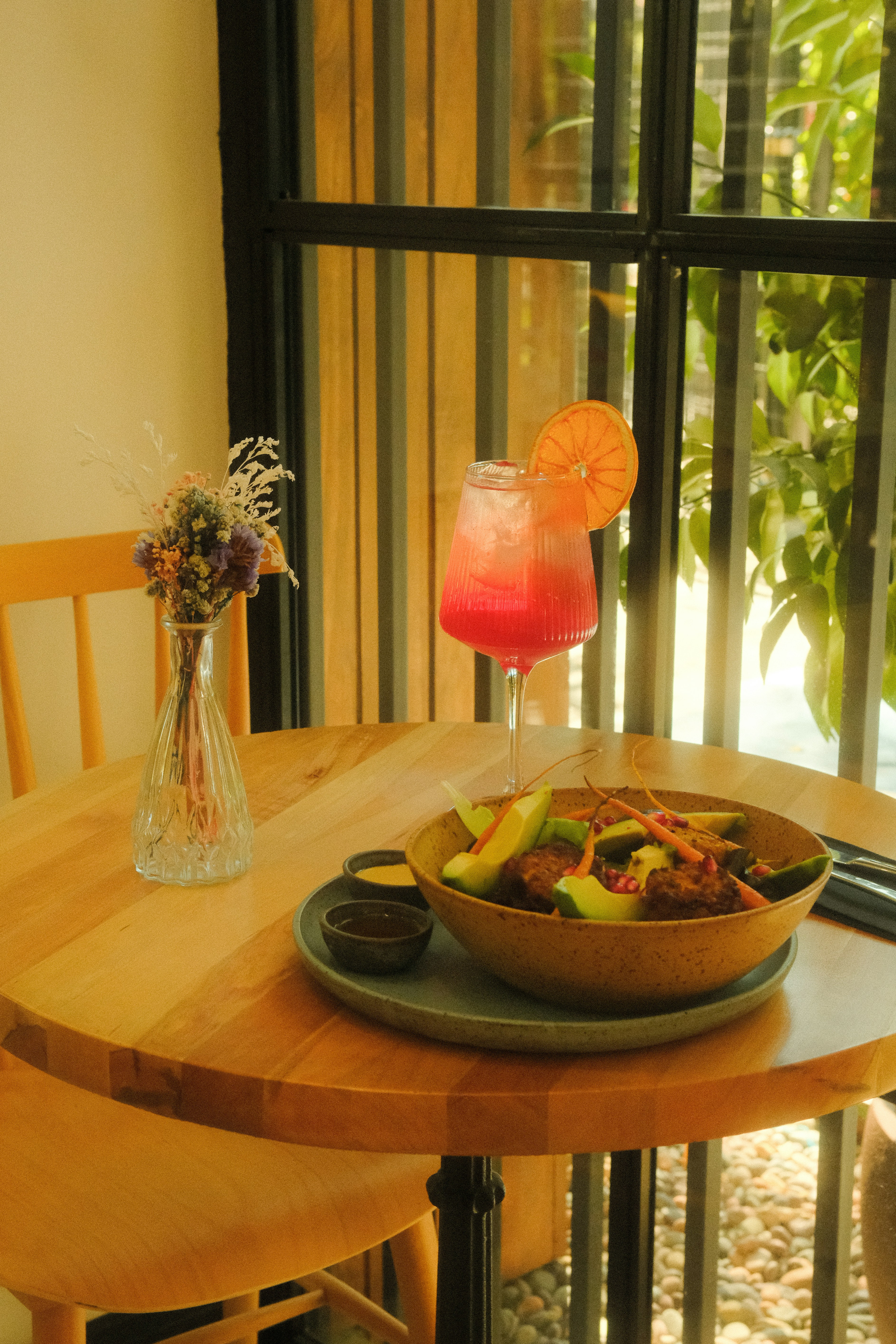 A meal with avocado and a pink drink