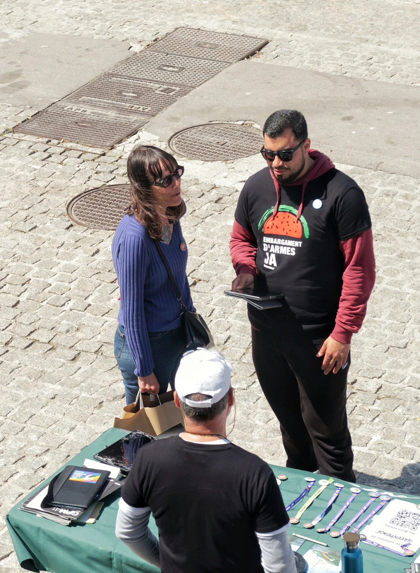Volunteer coordinators meeting at a community organizing table — the kind of nonprofit team that runs SMS marketing through CampaignCNX+