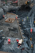 Construction workers building a large foundation