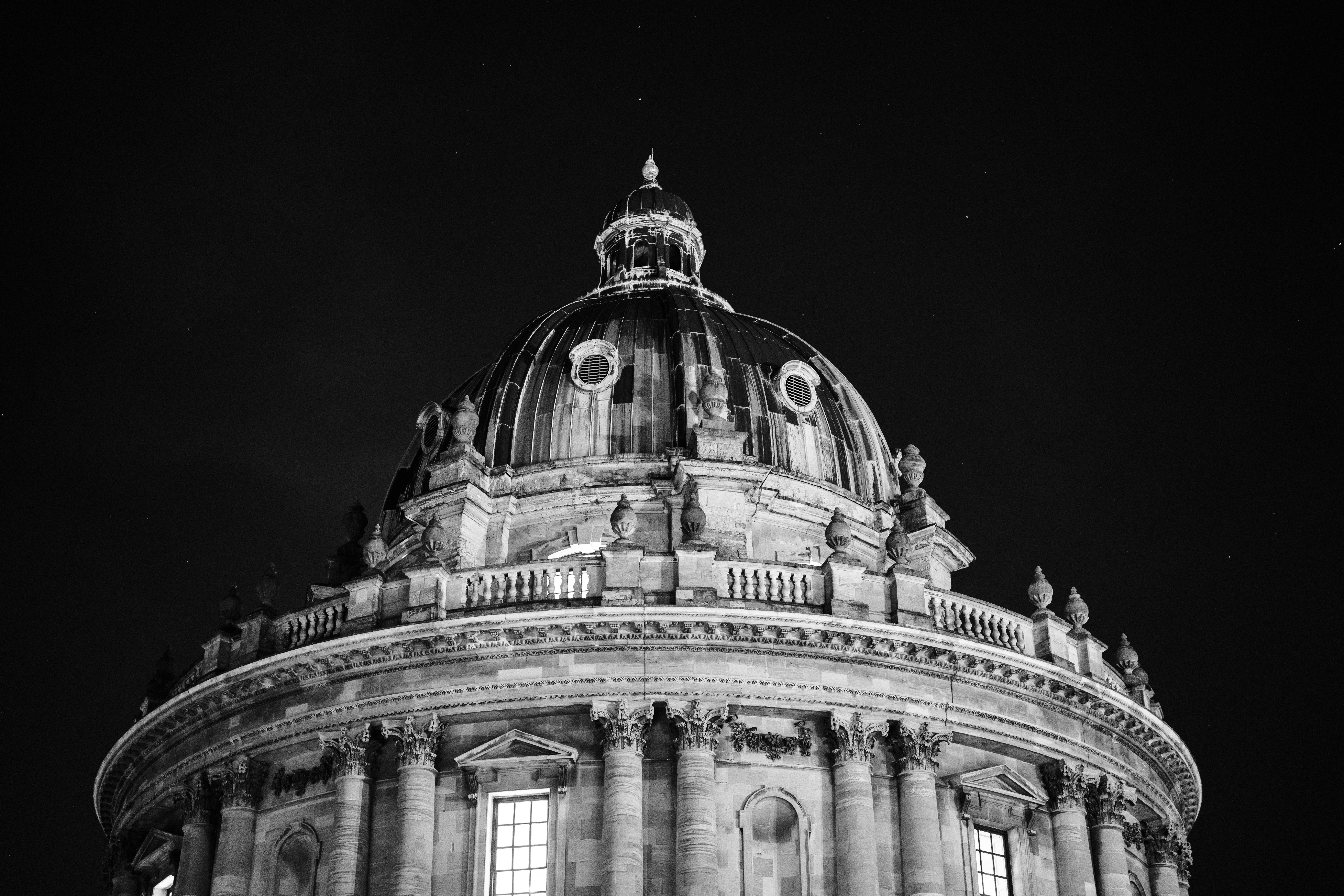 Grand dome building illuminated at night with stars.