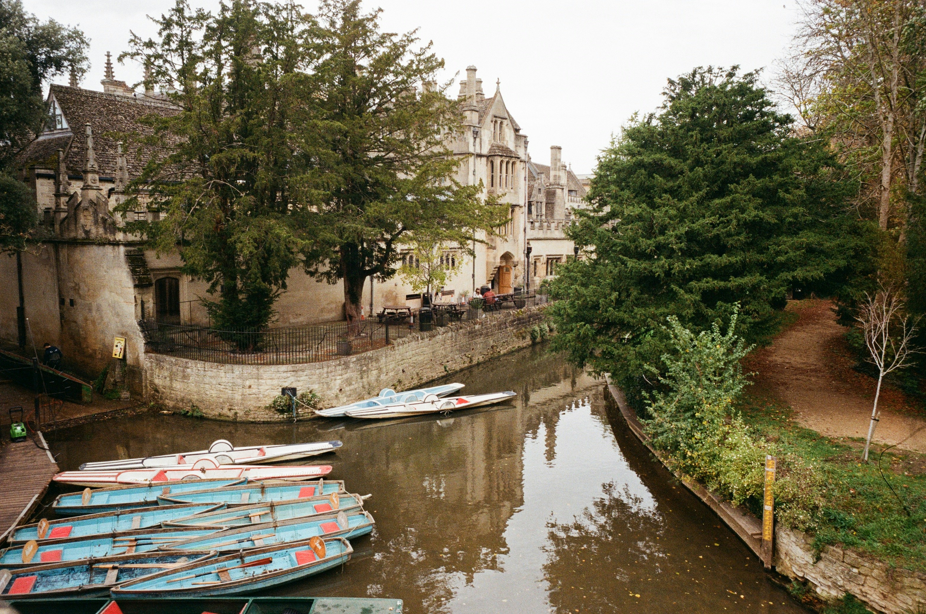 Boats docked along a canal next to historic buildings.