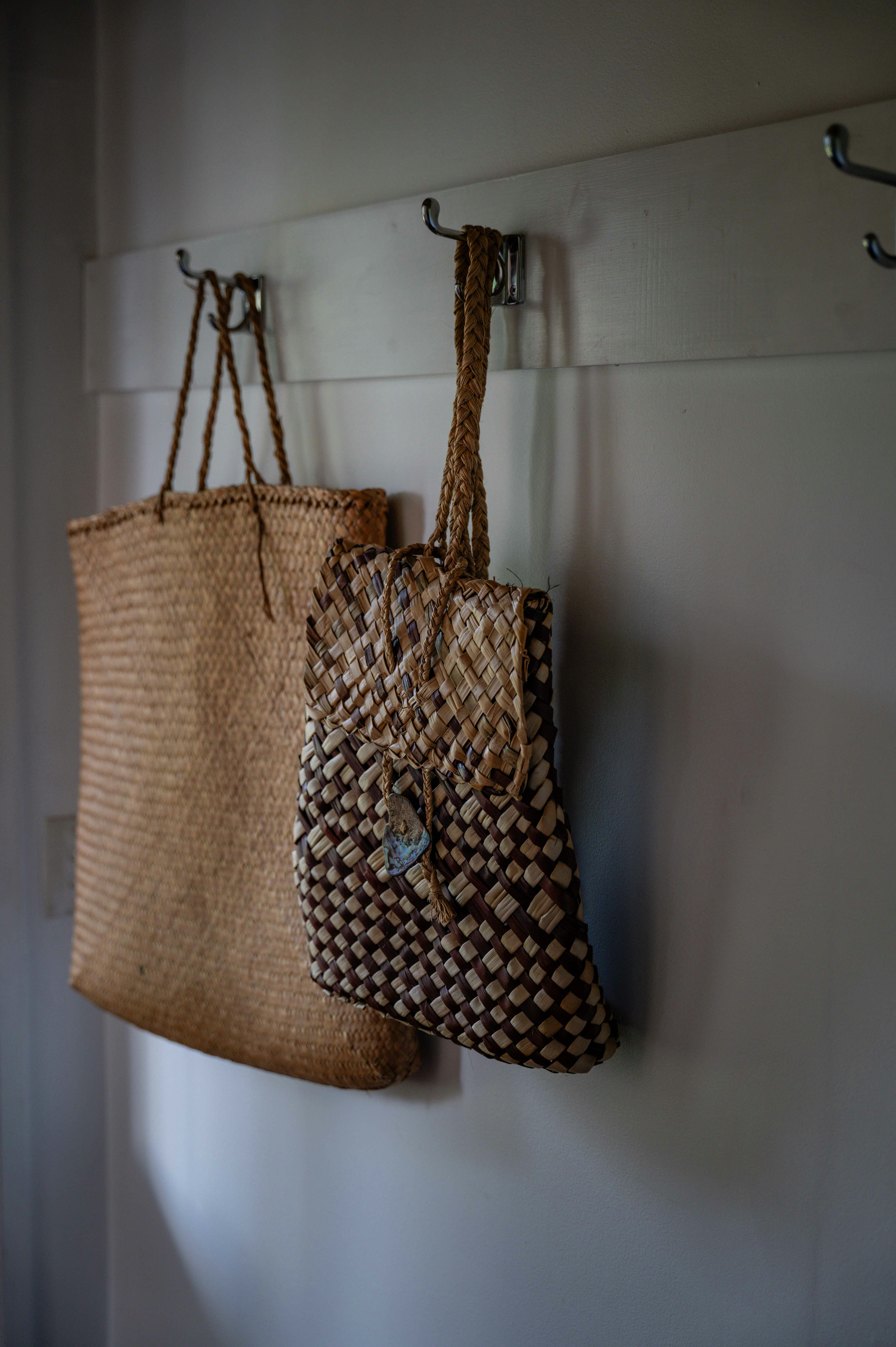 Two woven bags hanging on a wall