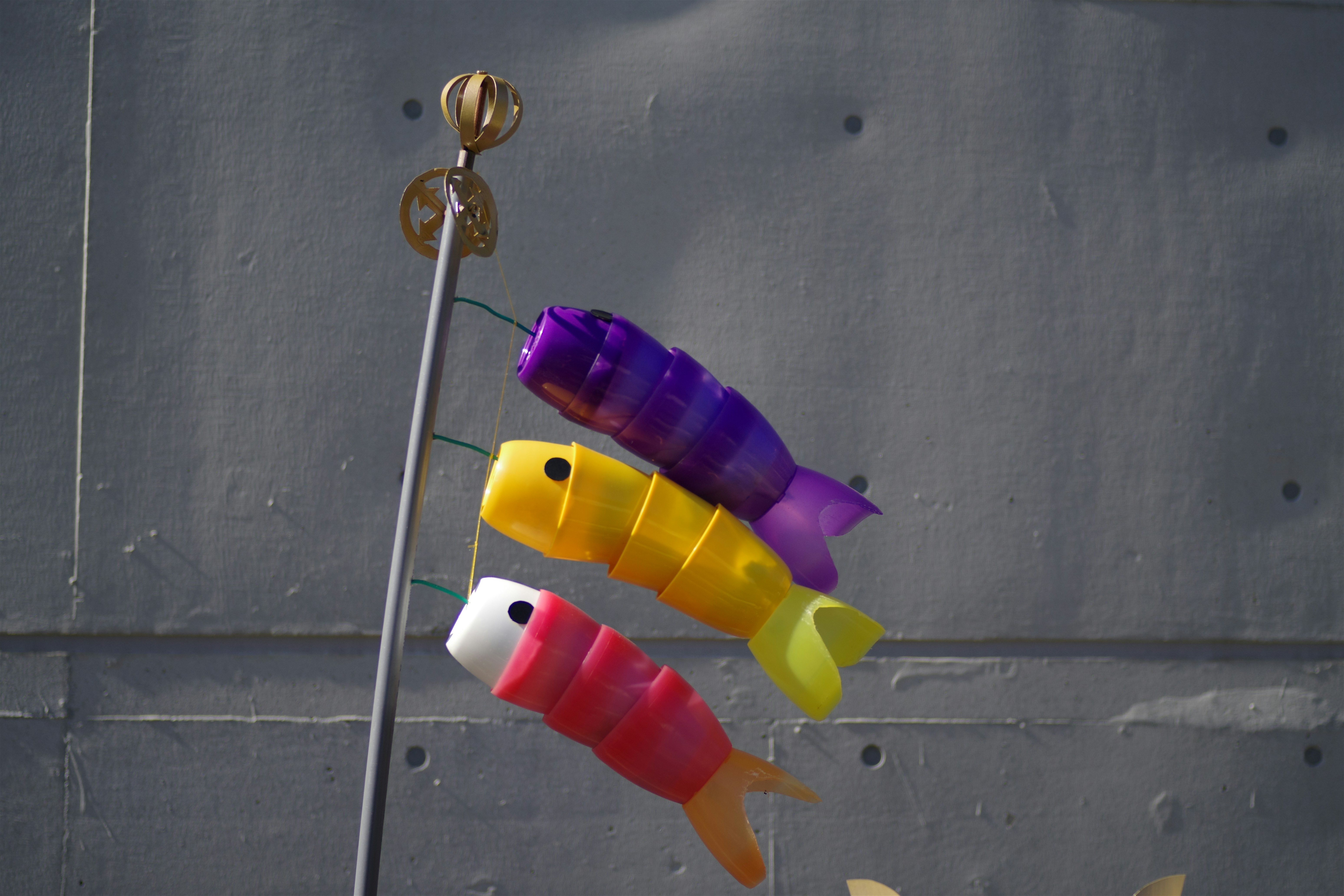 Three colorful carp streamers hanging on a pole