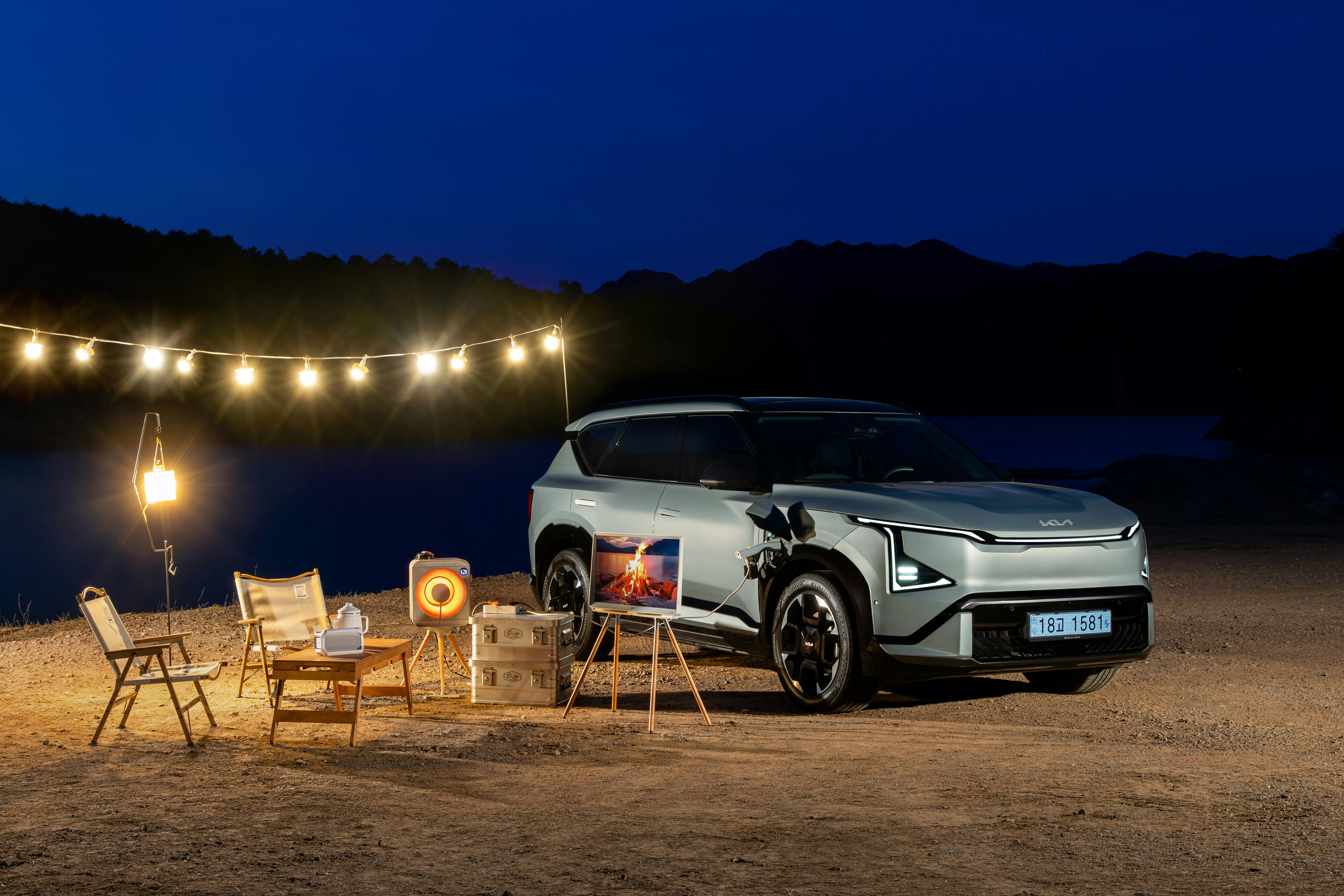 Car parked at campsite with string lights at night