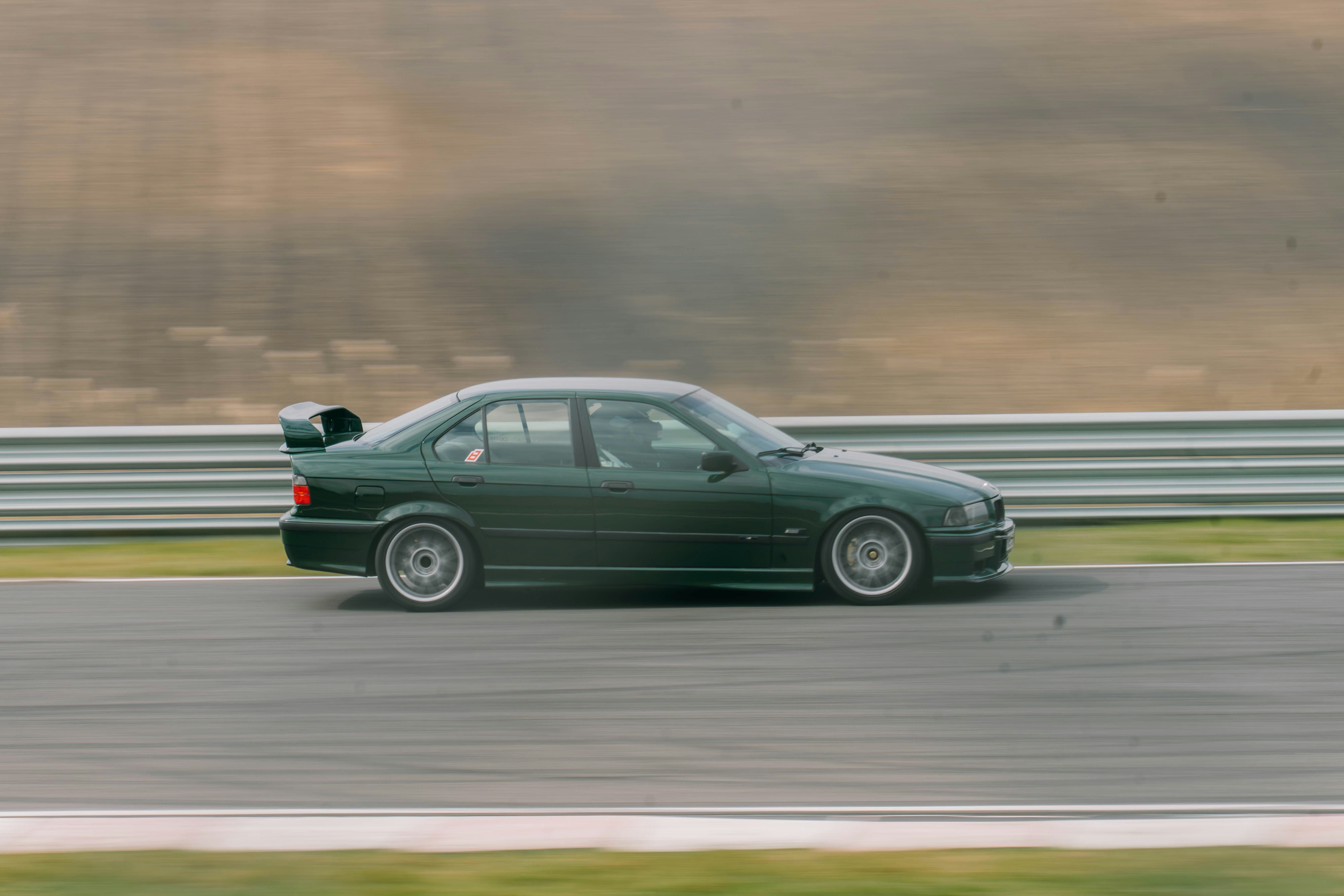 Berlina verde con spoiler in pista