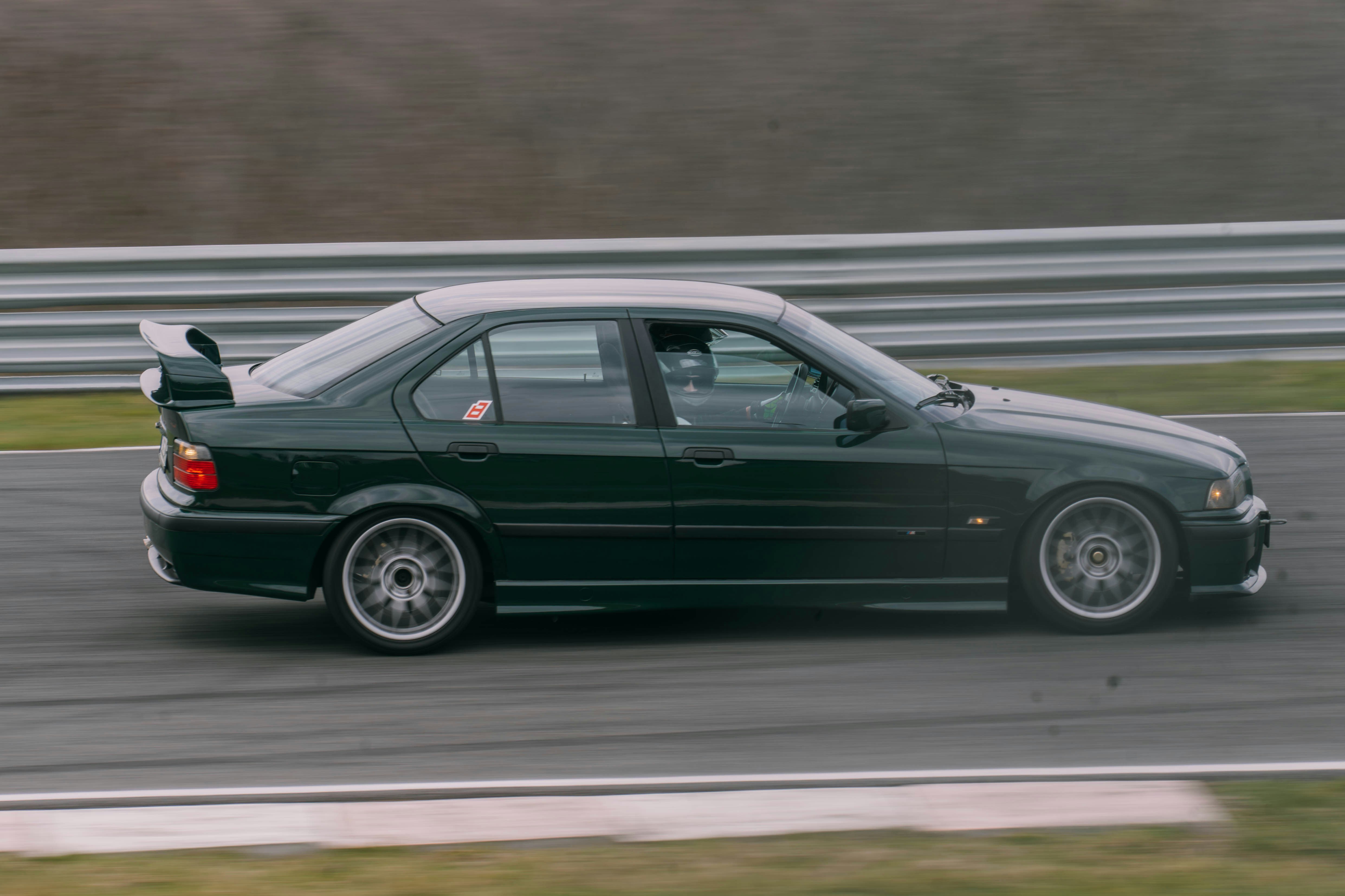 Berlina verde con spoiler in pista