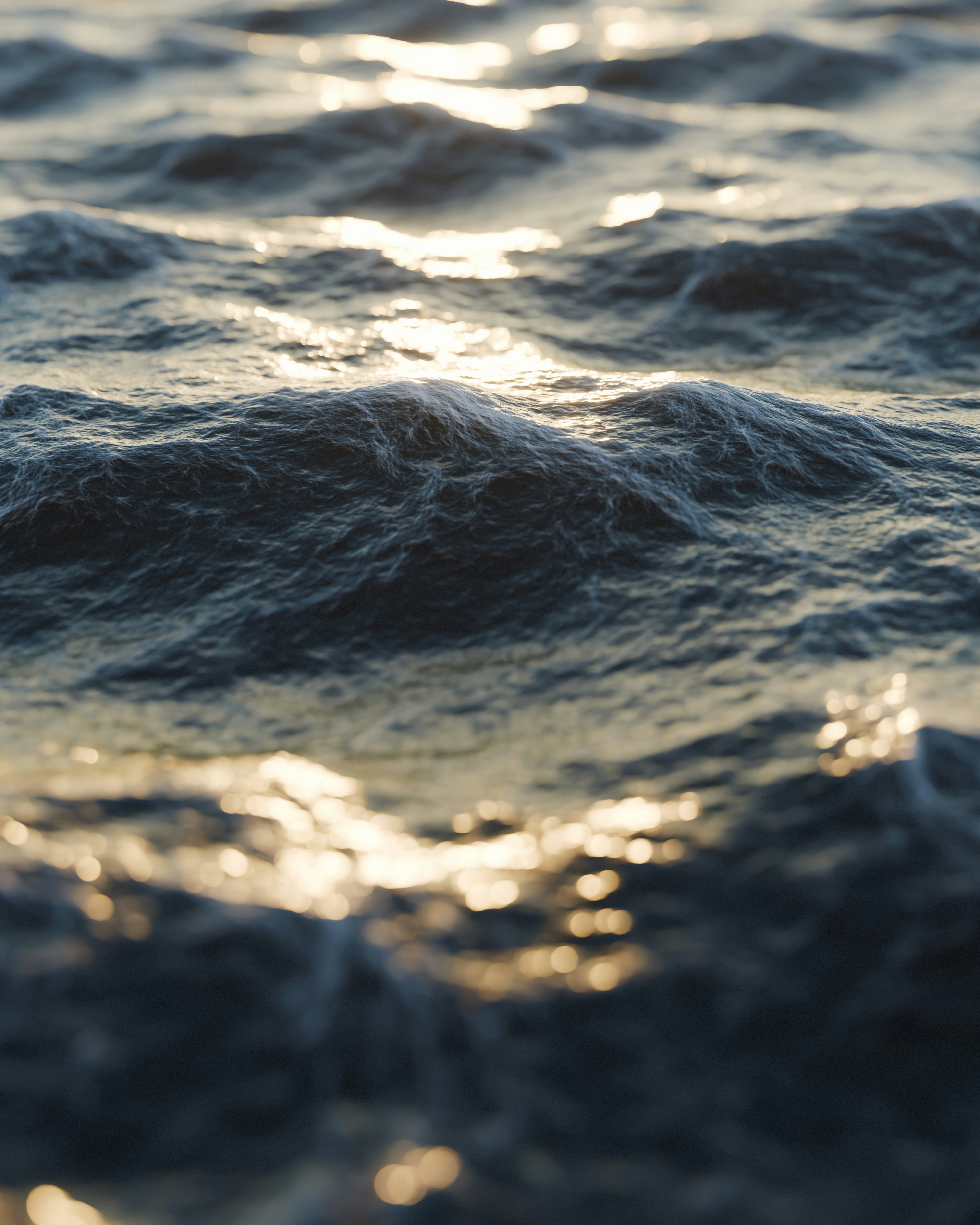 Rippling ocean water with golden sunlight reflection
