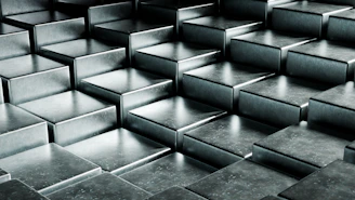 Abstract metallic cubes arranged in a stepped pattern.