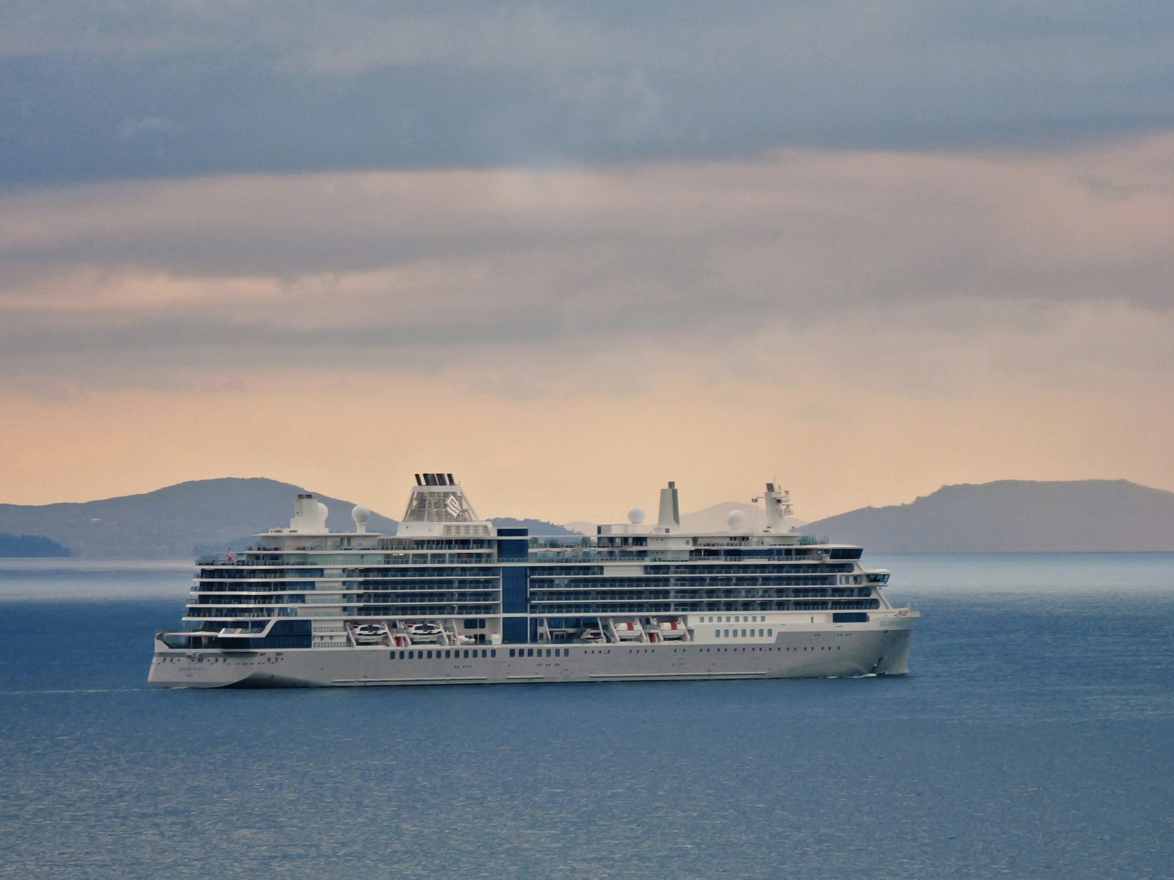 A large cruise ship sails on the ocean.