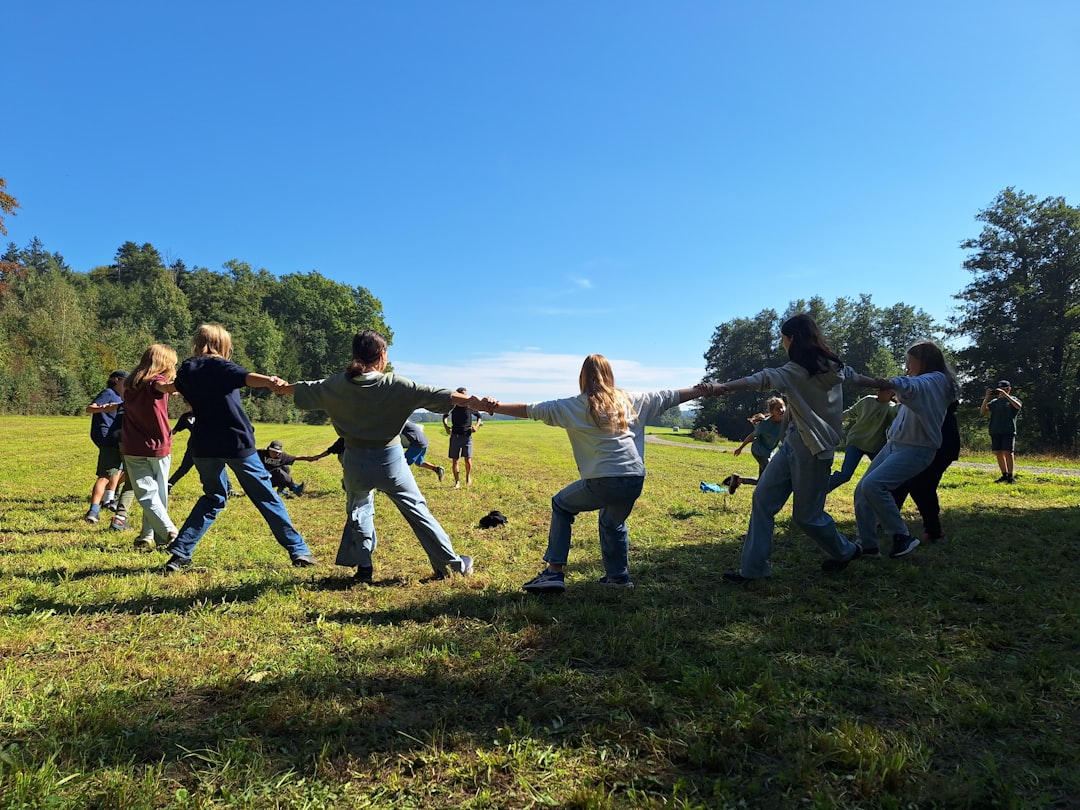 Young children playing an active running game together outdoors