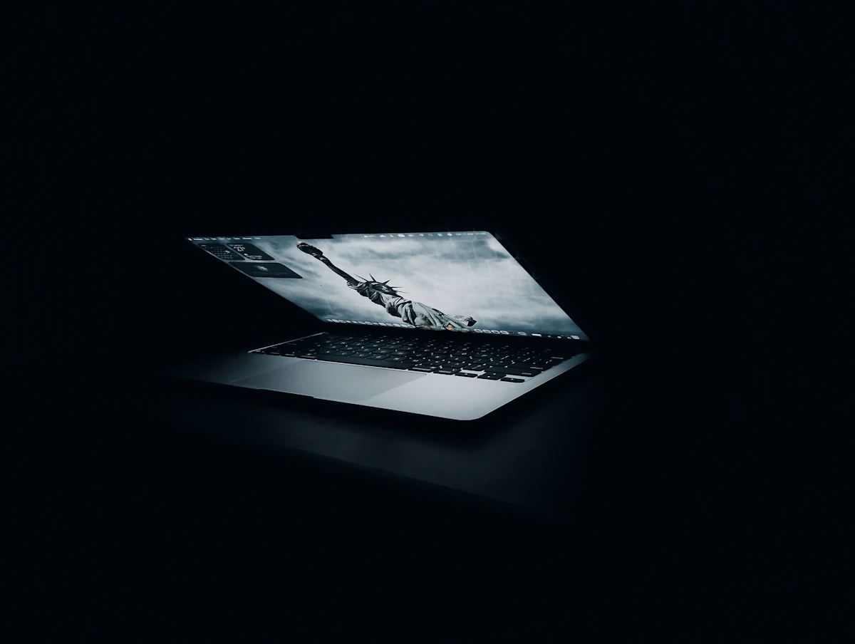 Laptop screen glowing in a dark room