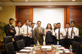 A group of people posing in a conference room.