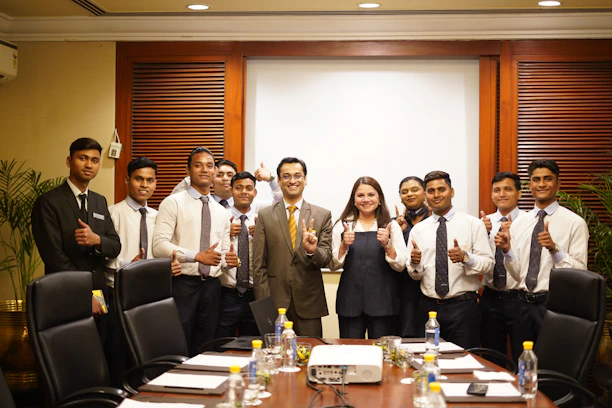 A group of people posing in a conference room.