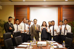 A group of people posing in a conference room.