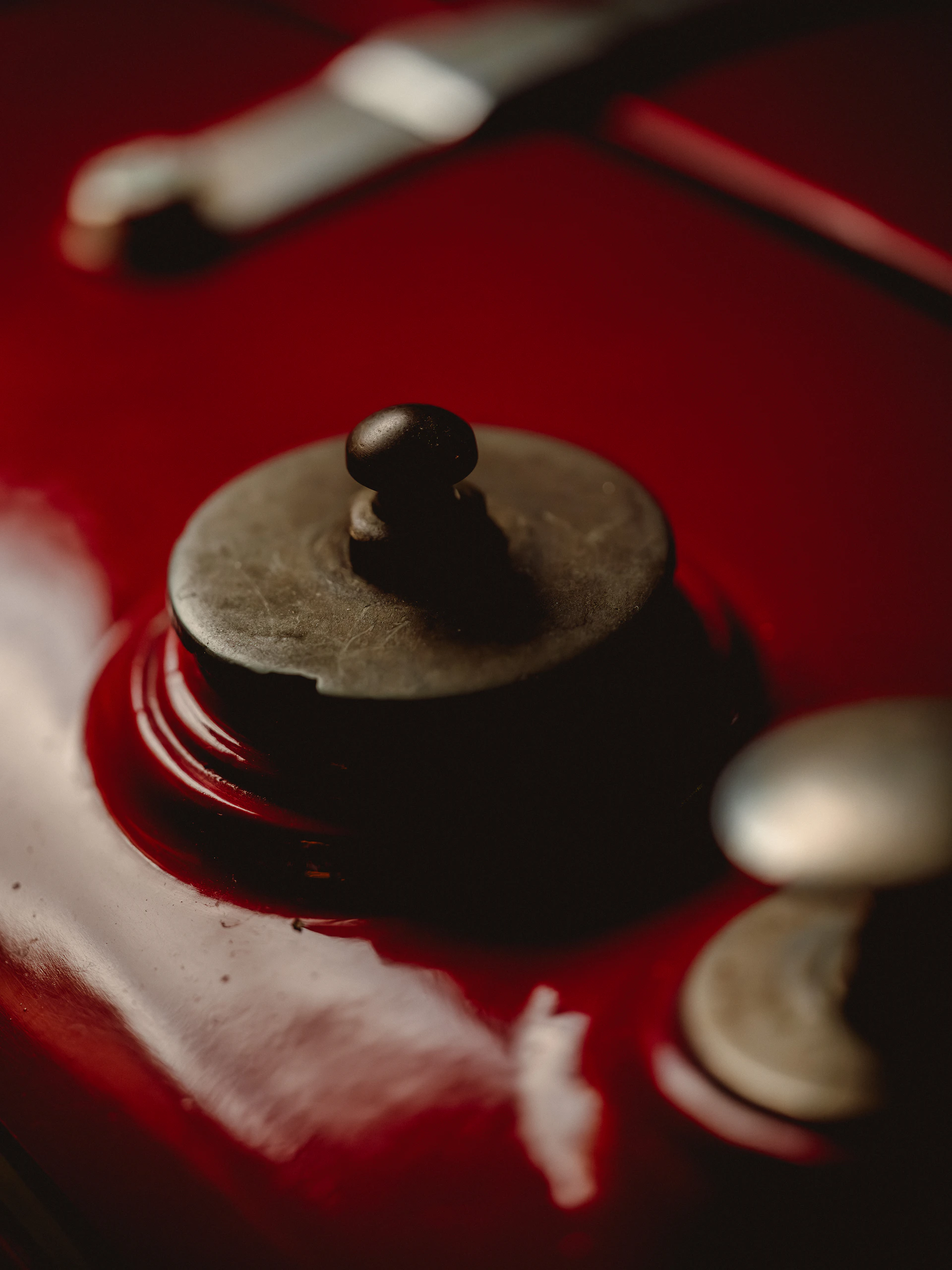 Close-up of a red surface with metal knobs.