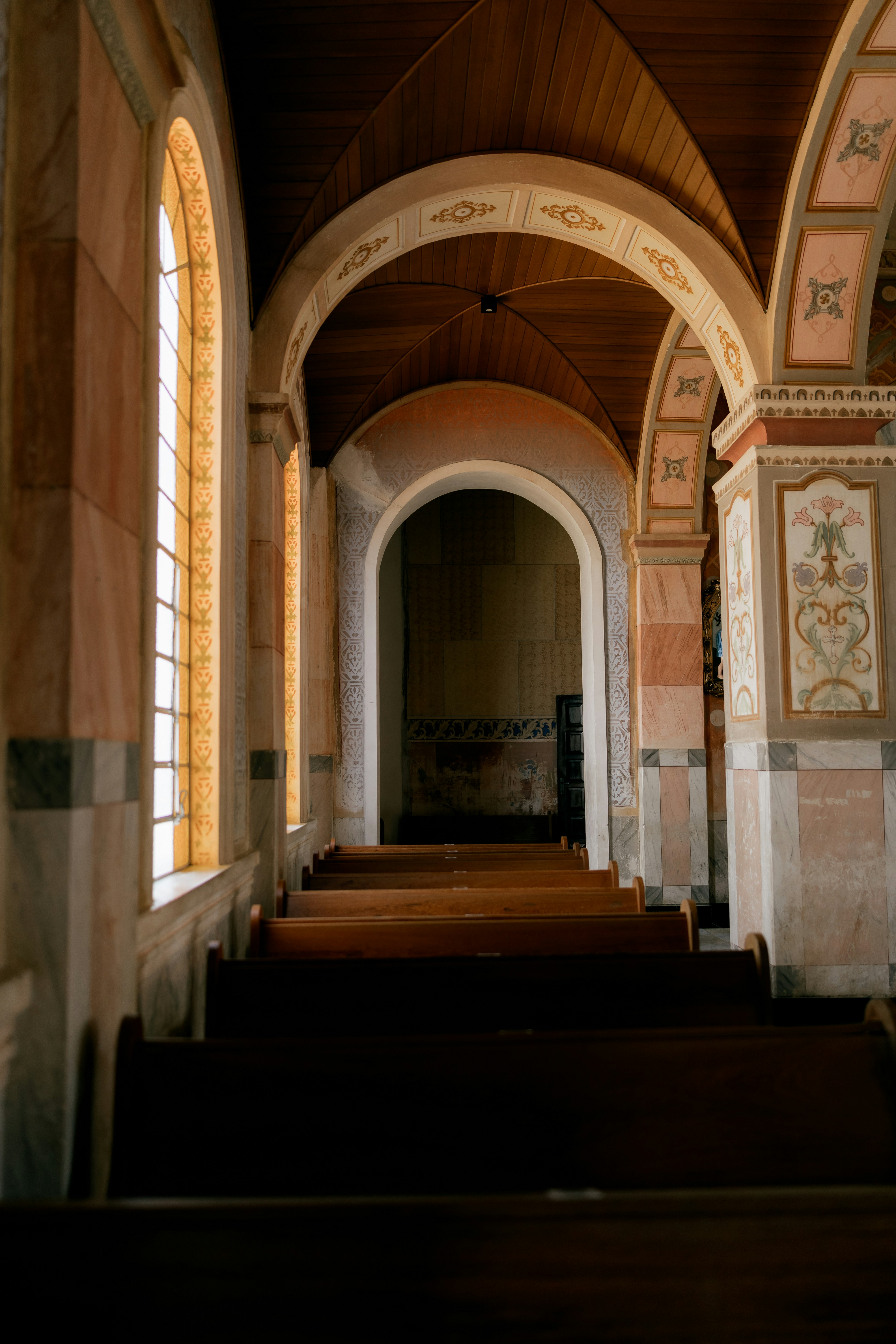 Rows of wooden pews in a church hallway