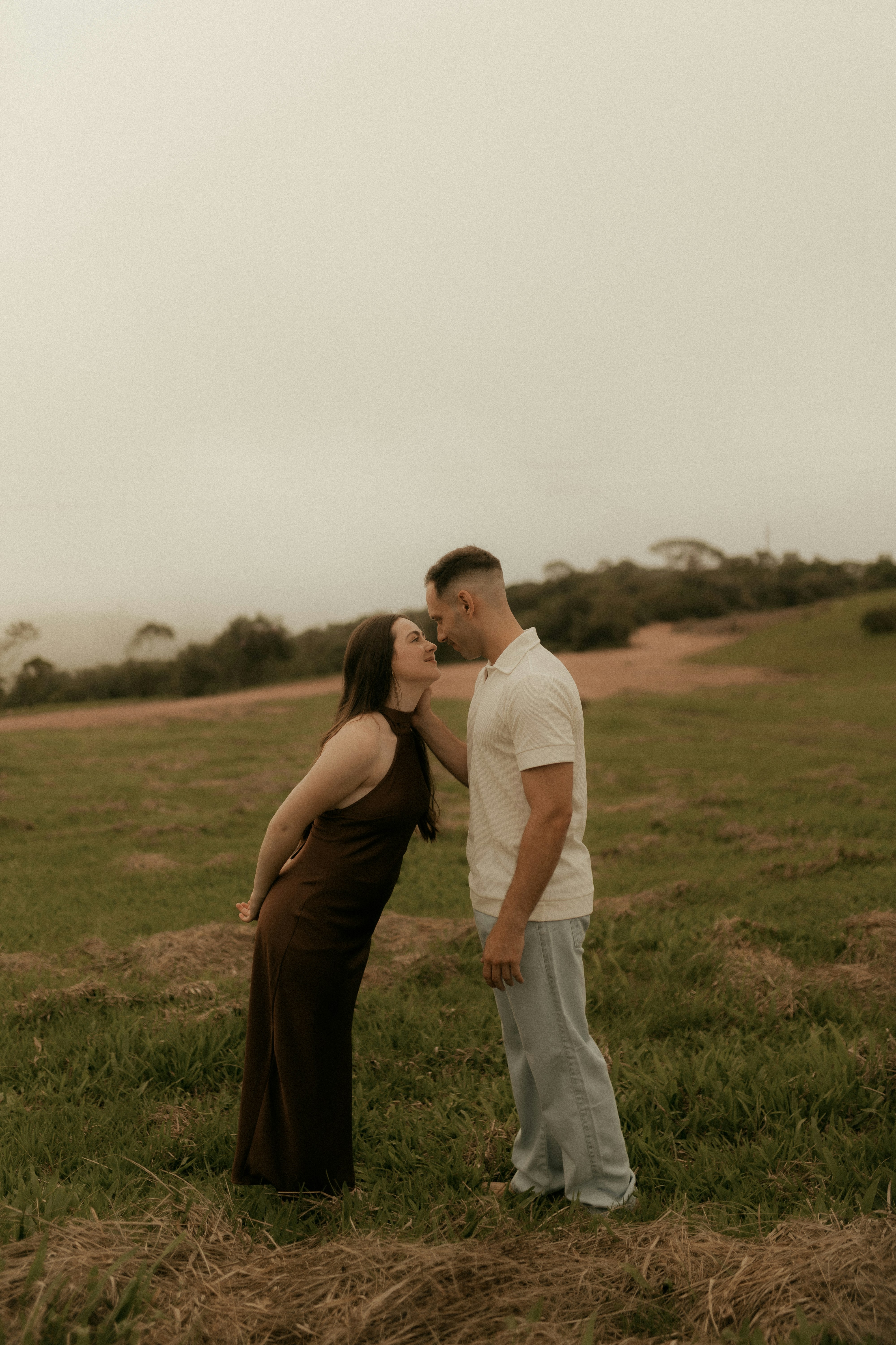 Couple embracing in a grassy field