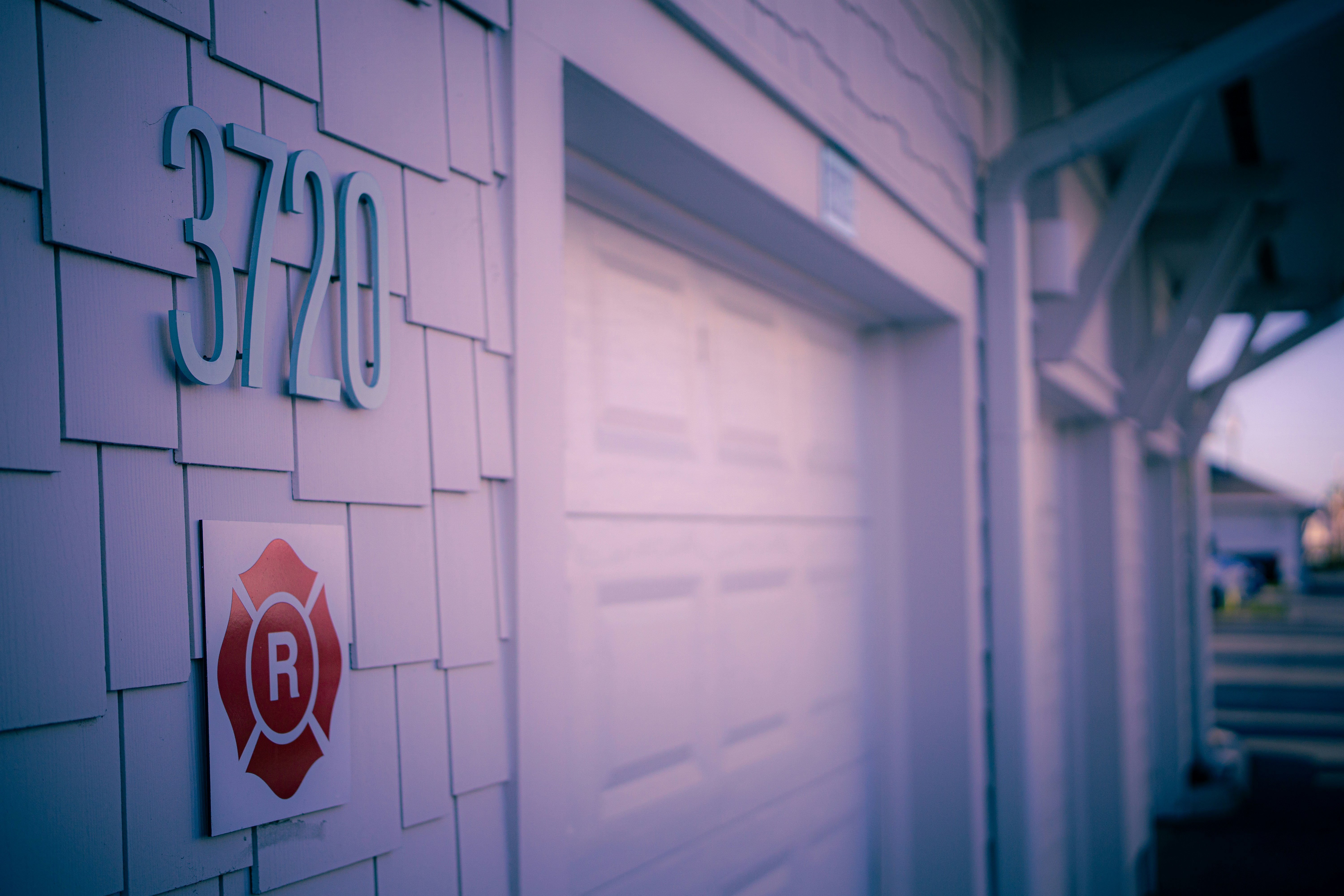 House number 3720 on shingled wall next to garage.