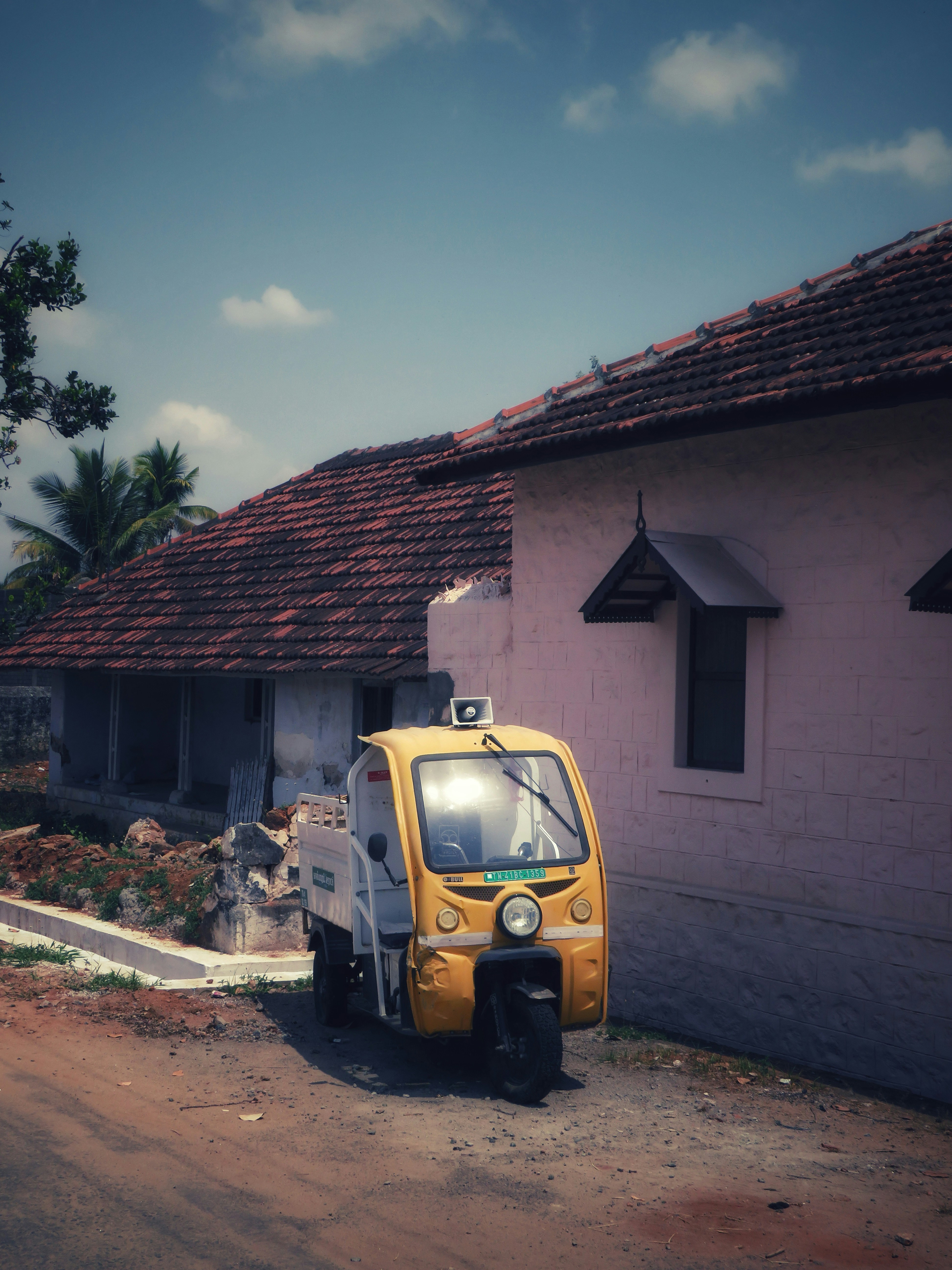 Yellow auto-rickshaw parked outside a building photo – Free Travel ...