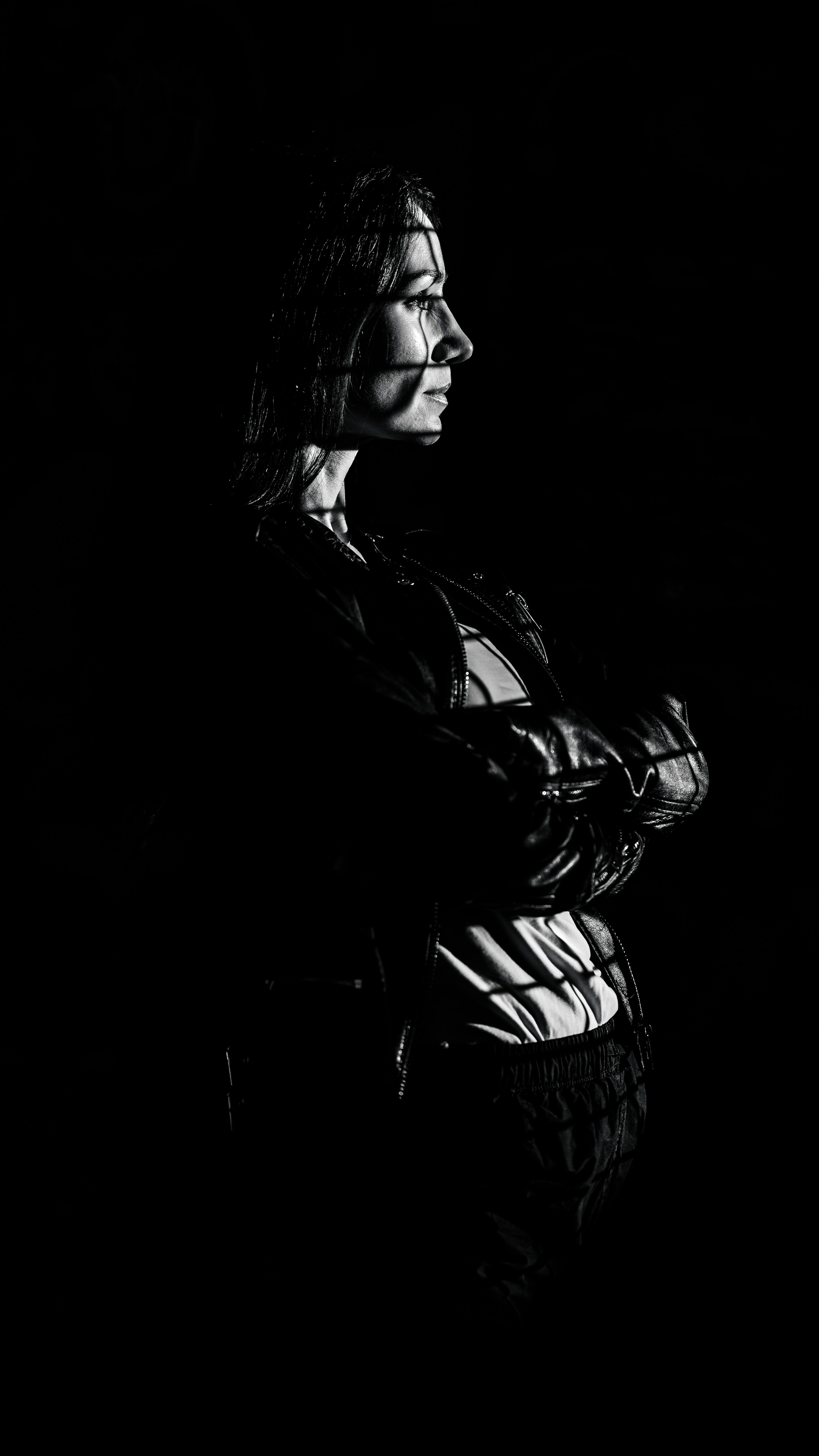 Woman with patterned light on her face and body.