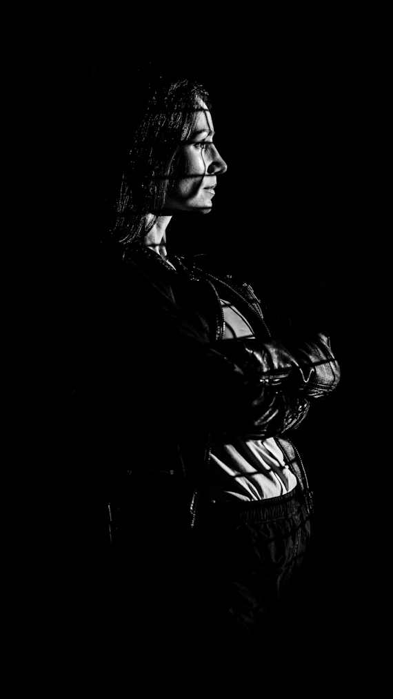Woman with patterned light on her face and body.