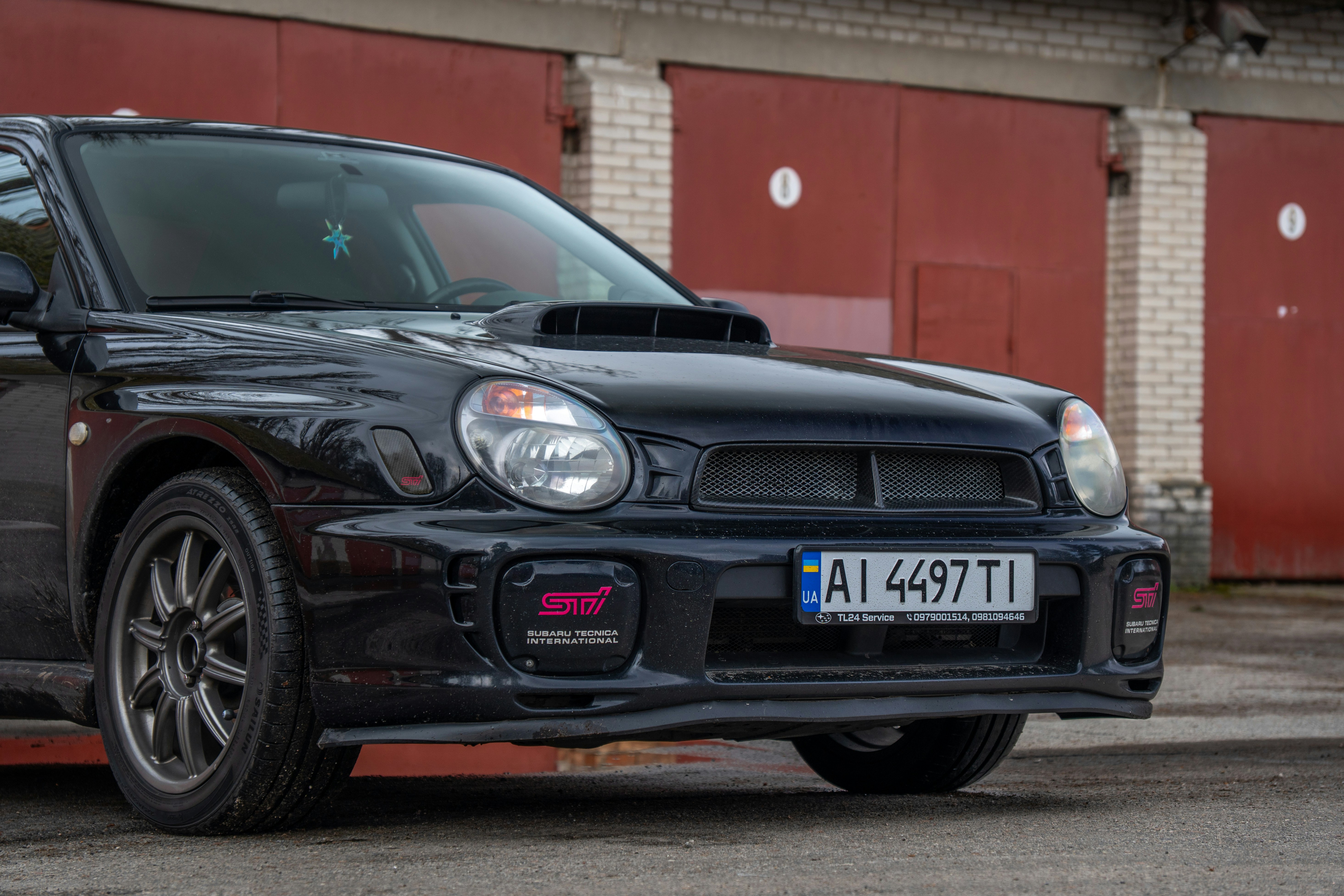 Black subaru impreza wrx sti parked outdoors.