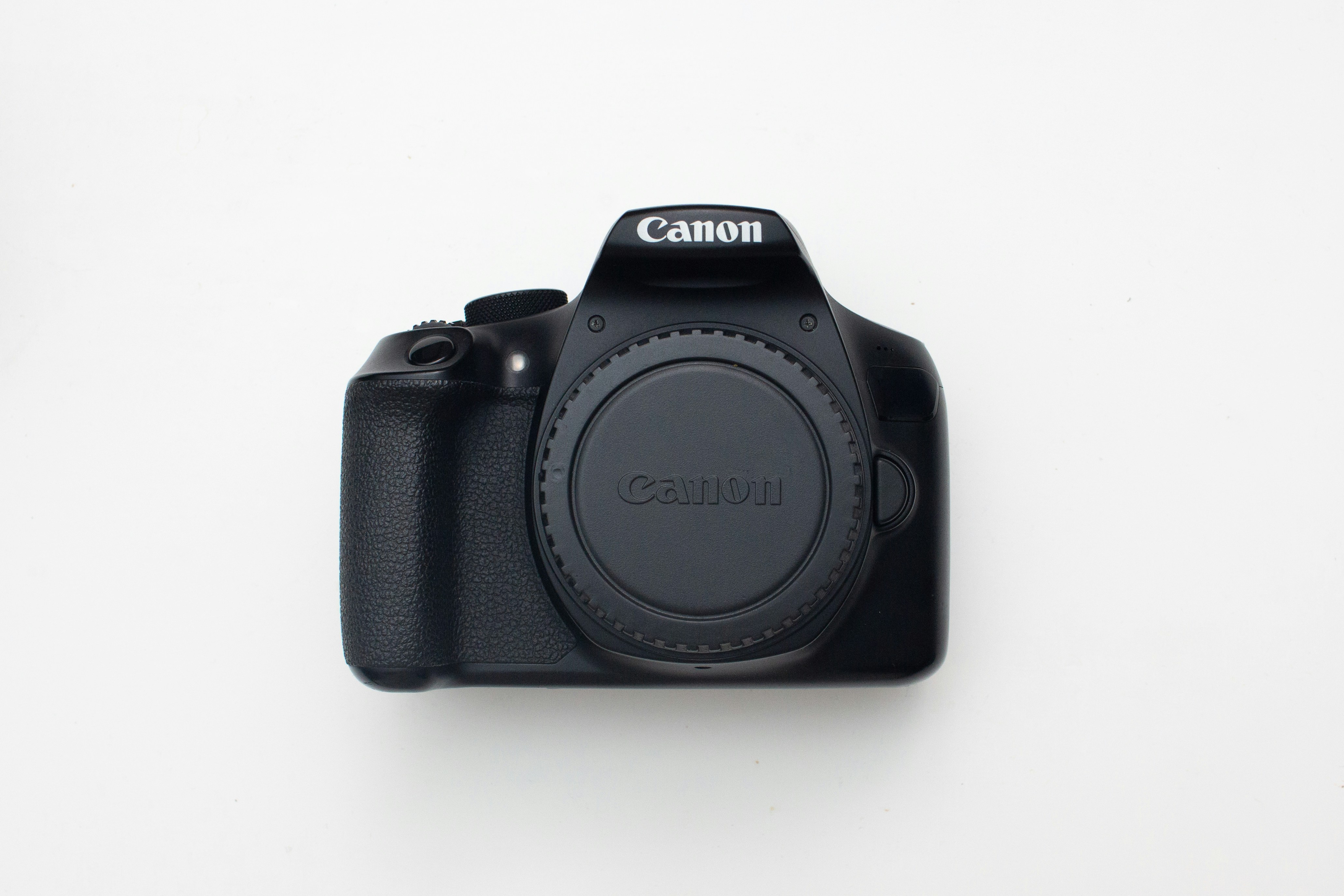 A black canon dslr camera on a white background
