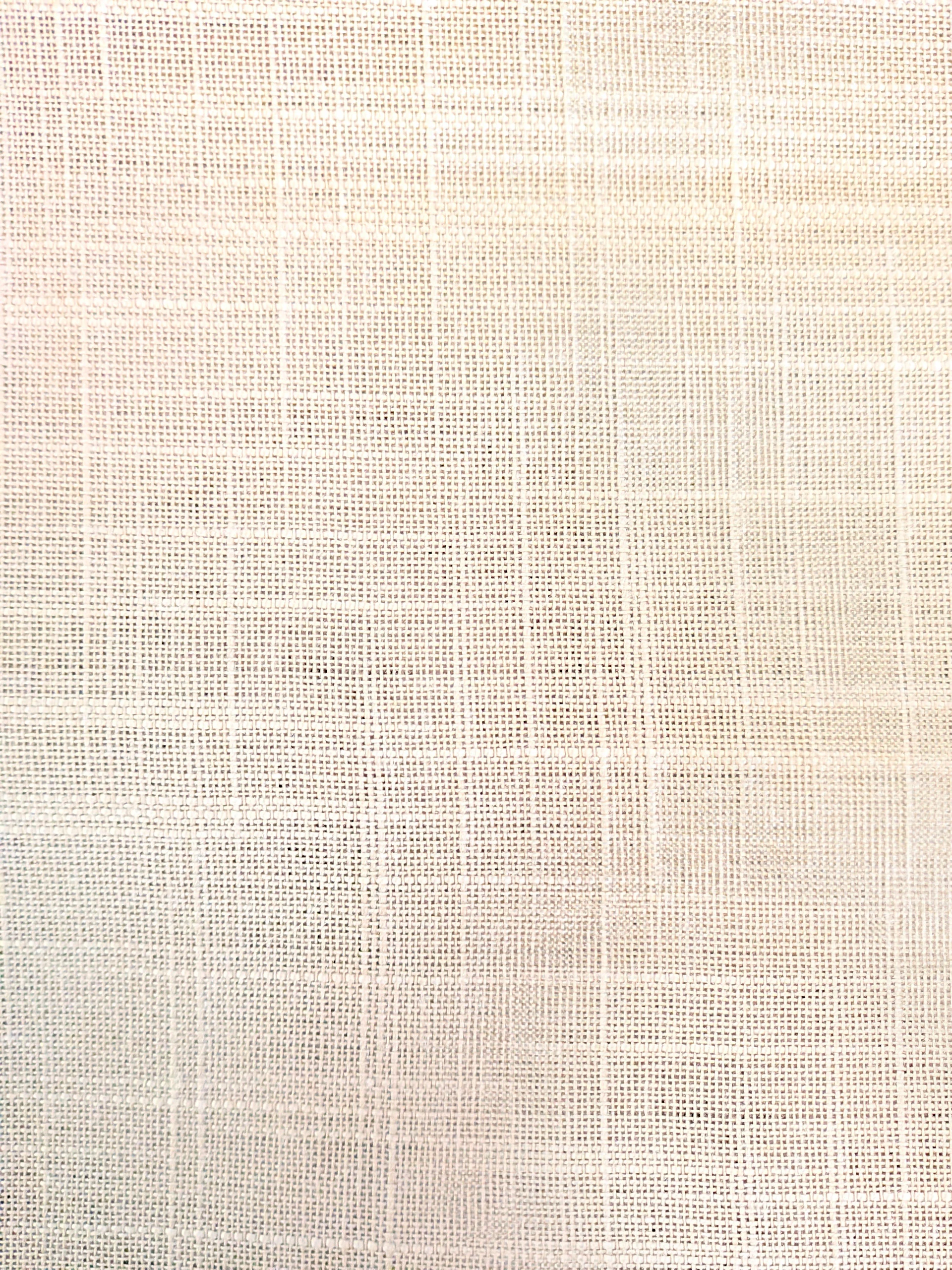A light beige textured fabric with a grid pattern