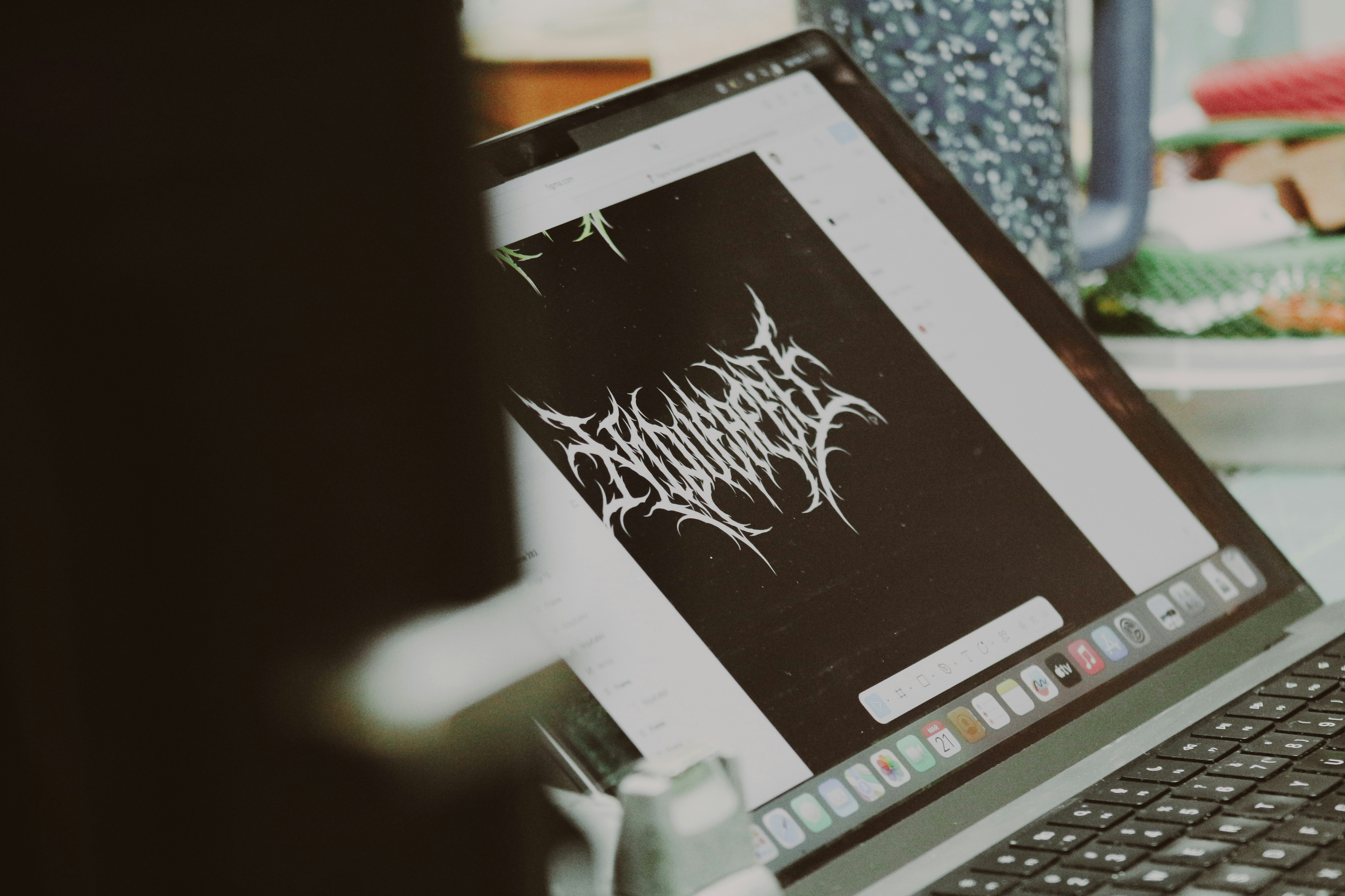 Person looking at a laptop displaying a logo.