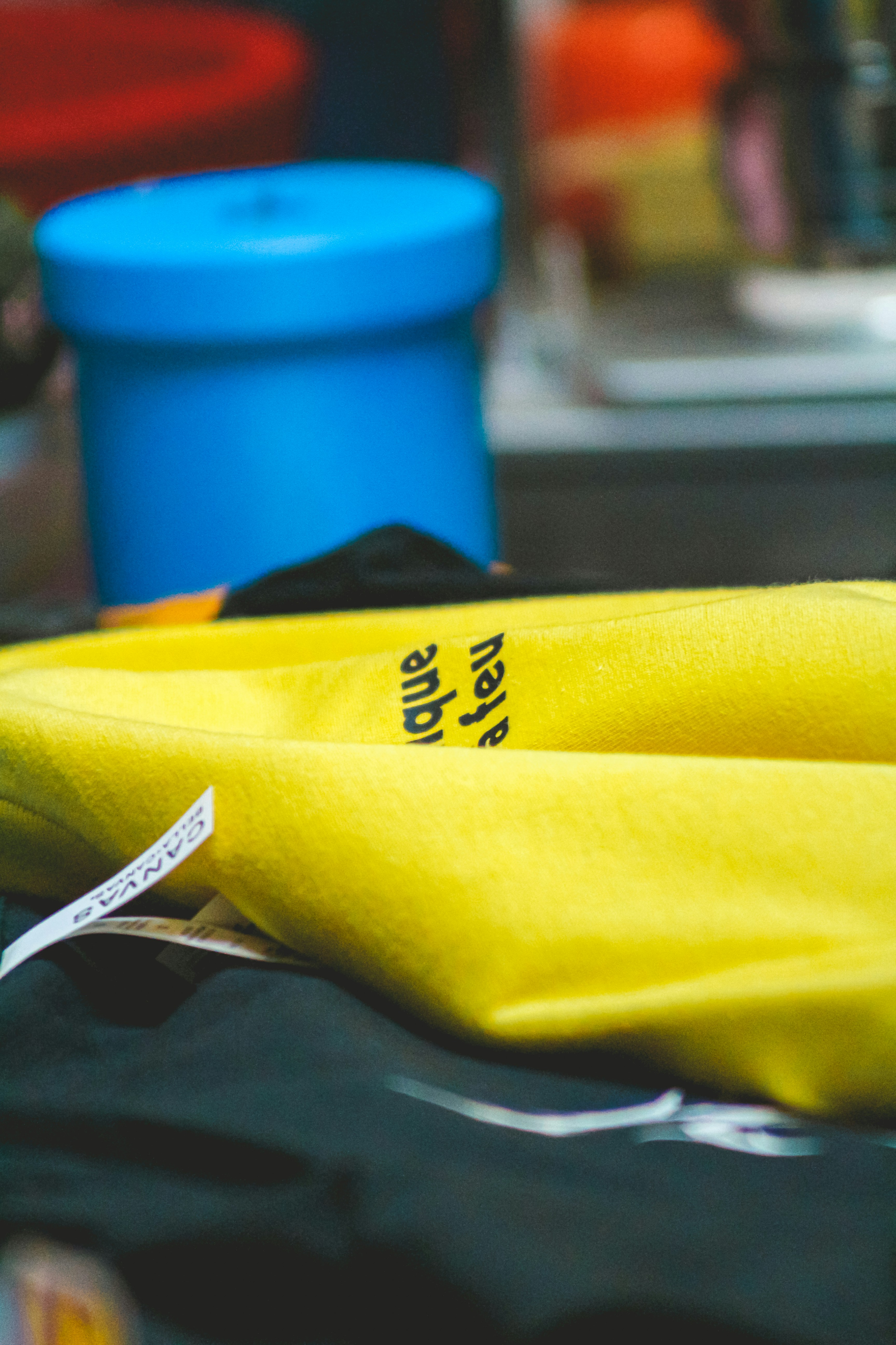 Yellow fabric with black lettering and white text.