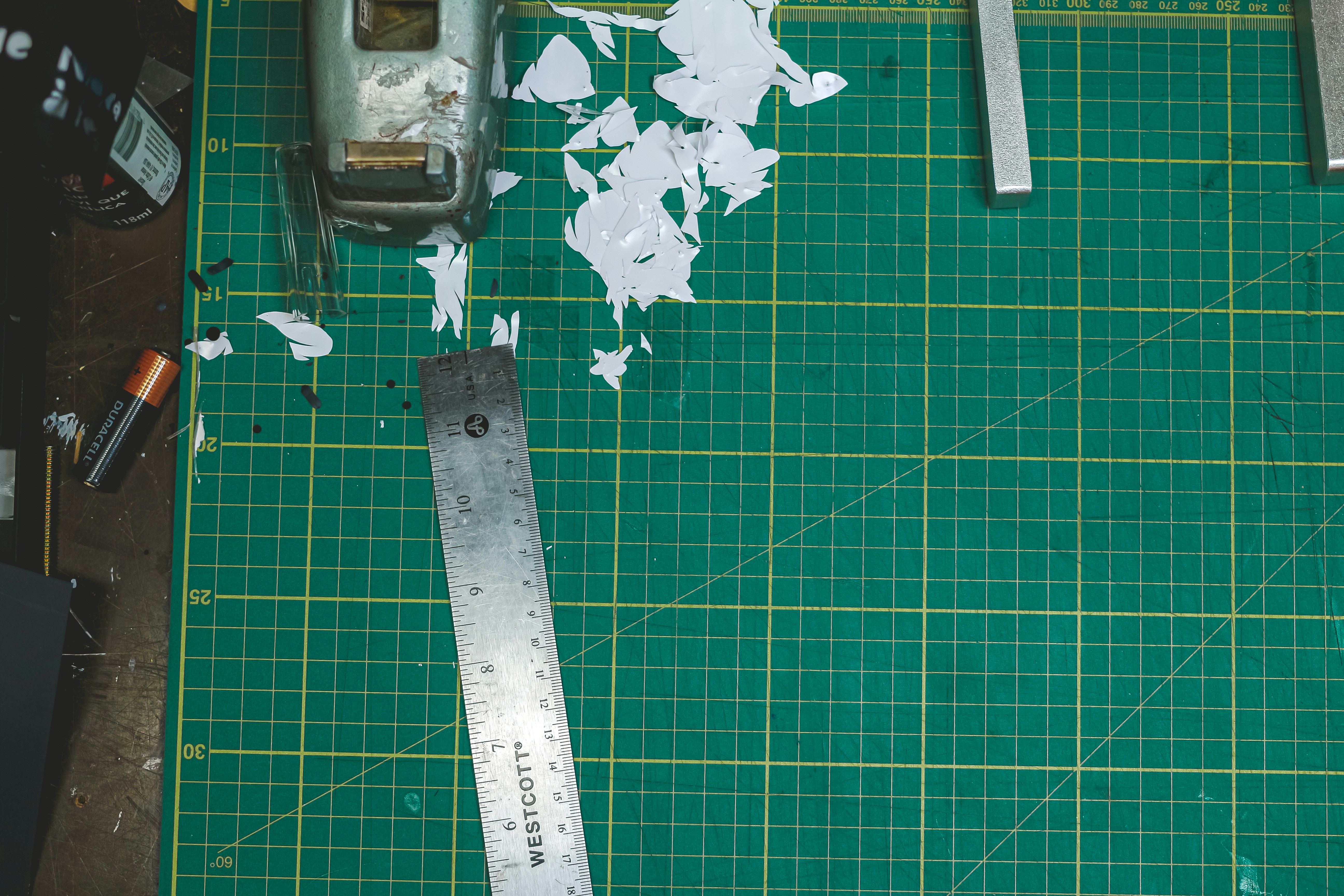 Cutting mat with ruler and debris