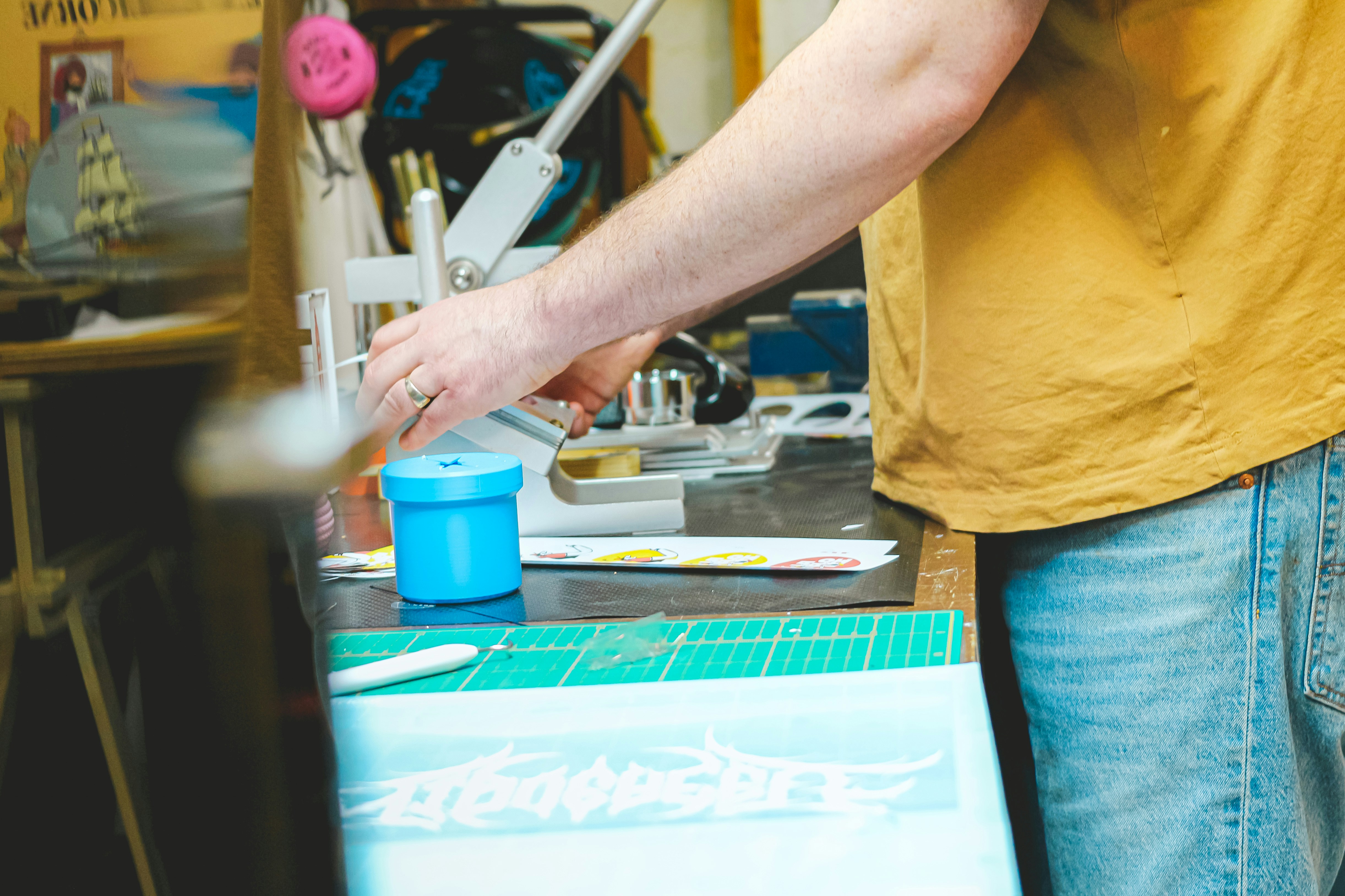 Person working at a craft table with tools.