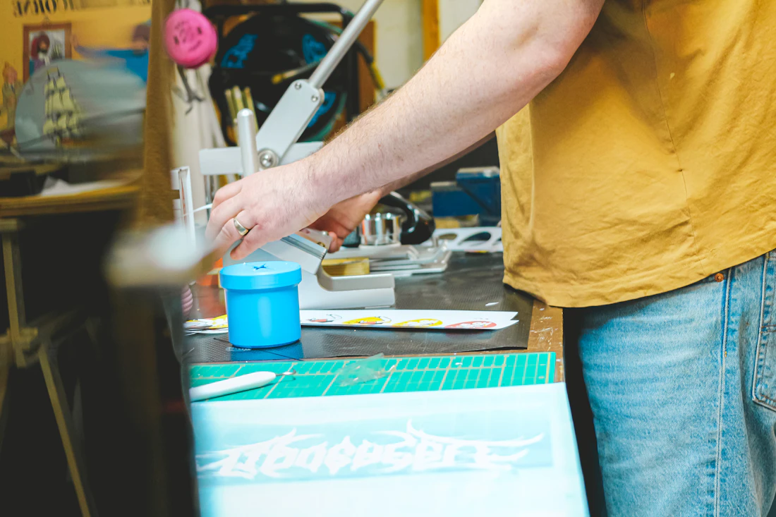 Craftsperson working at a workshop table with tools