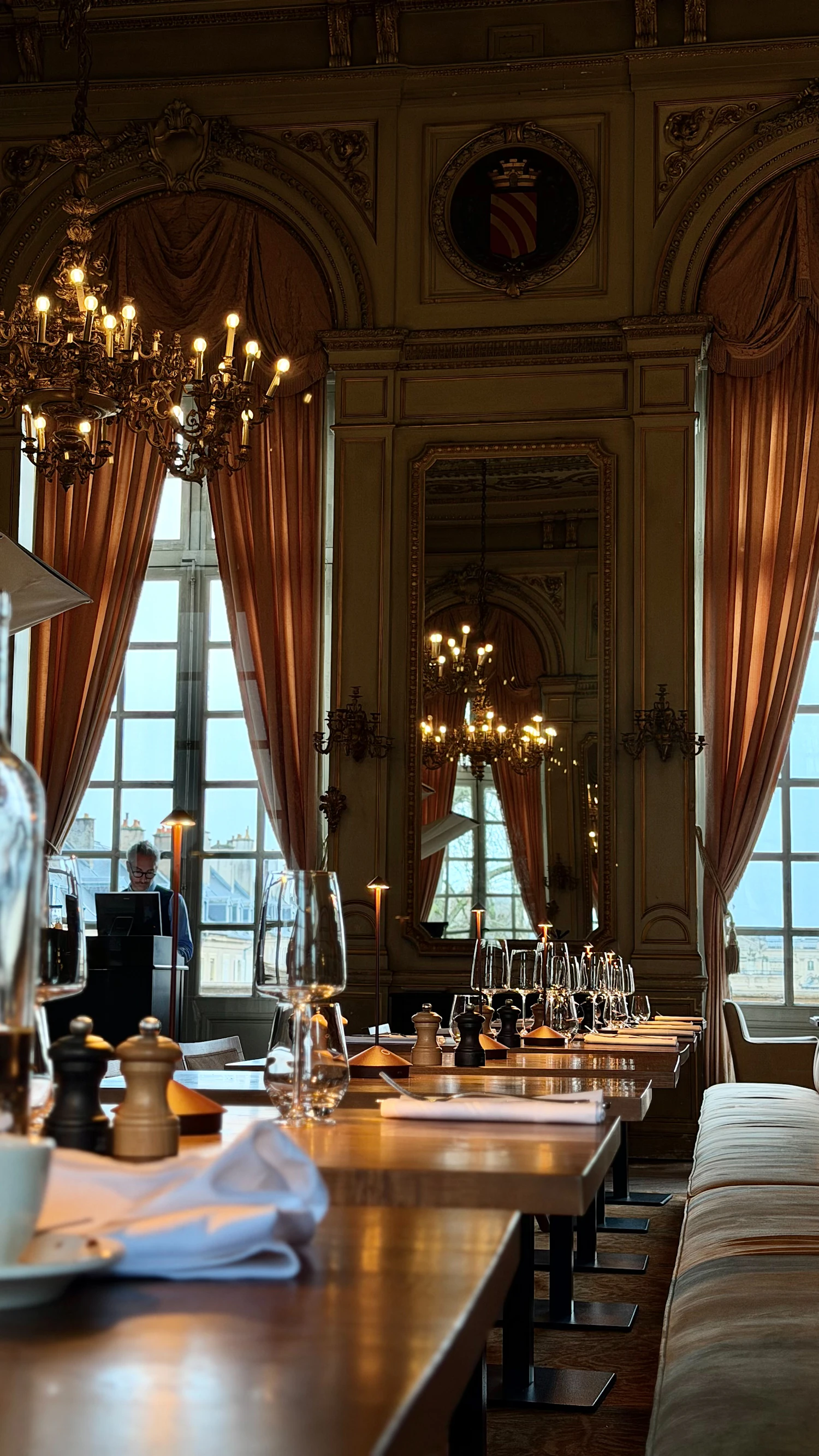 Elegant restaurant dining room with set tables and chandeliers