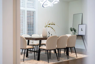 Elegant dining room with a large table and chairs.
