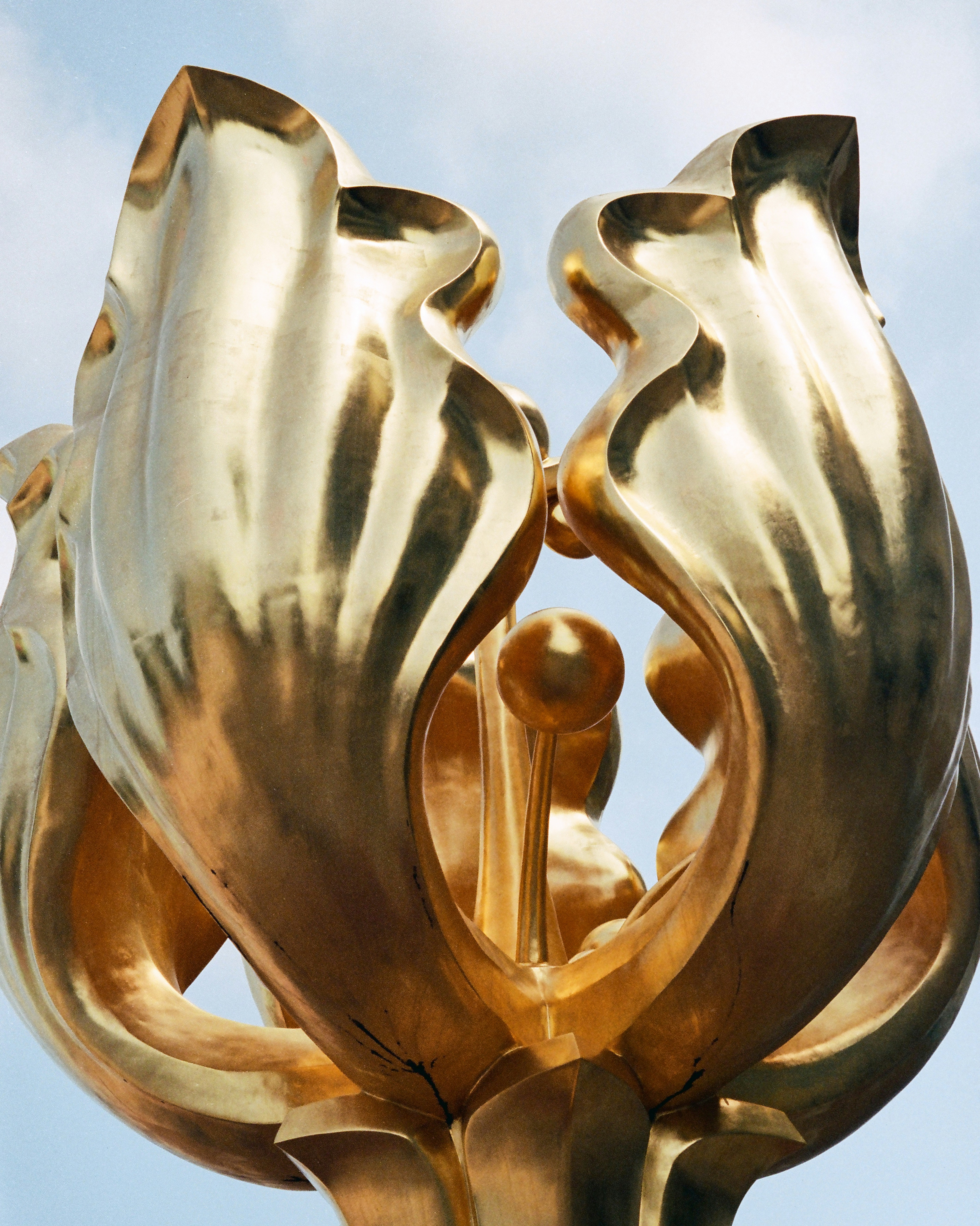 Large golden sculpture resembling a flower