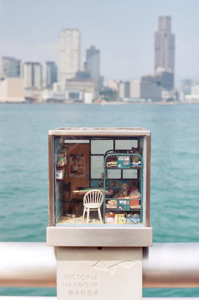 Miniature diorama of a room with city skyline background