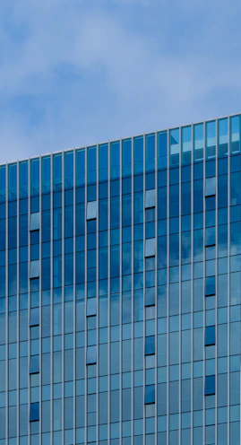 Modern building with blue glass facade and sky