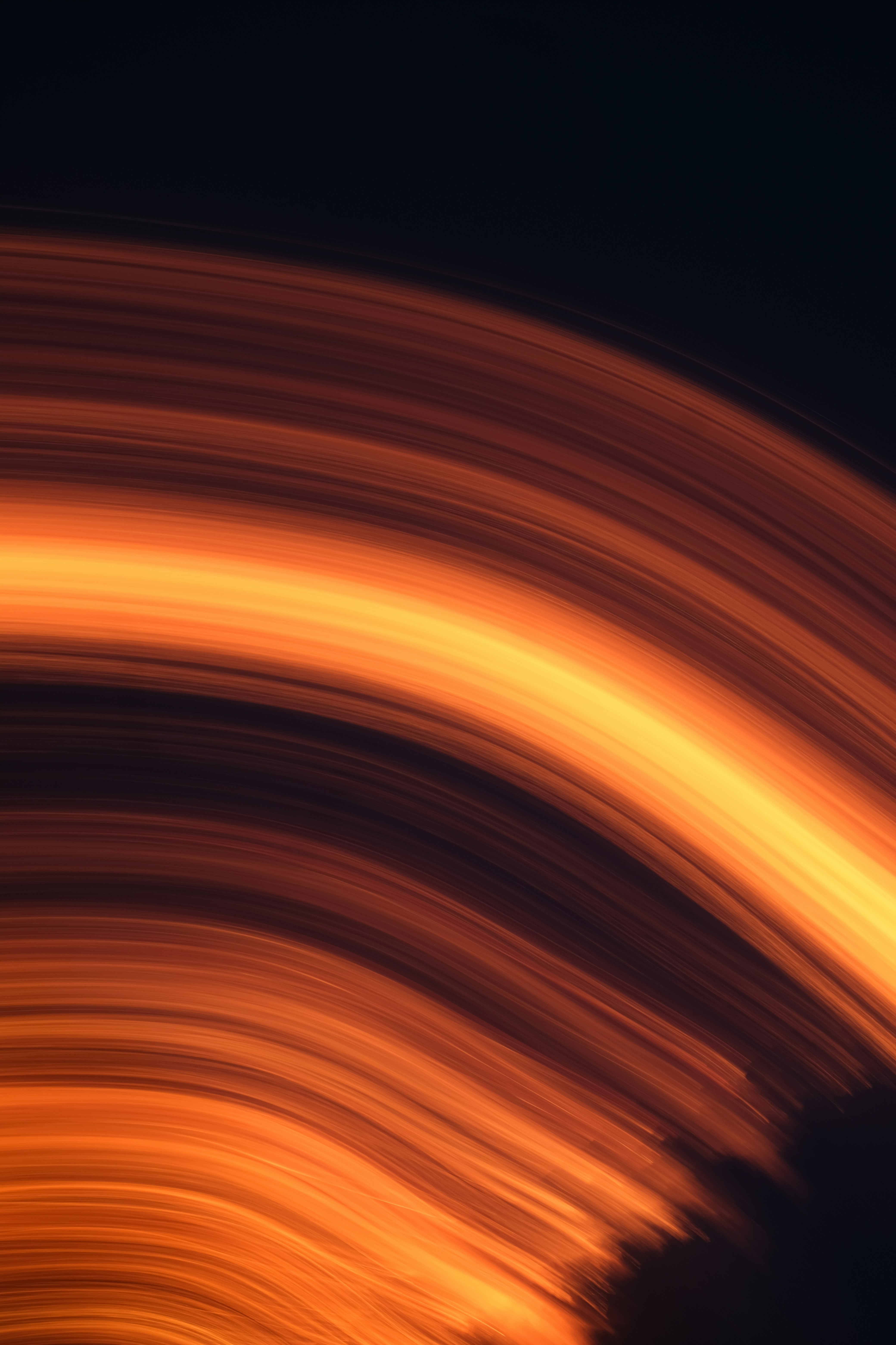 Abstract flowing lines of orange and yellow light