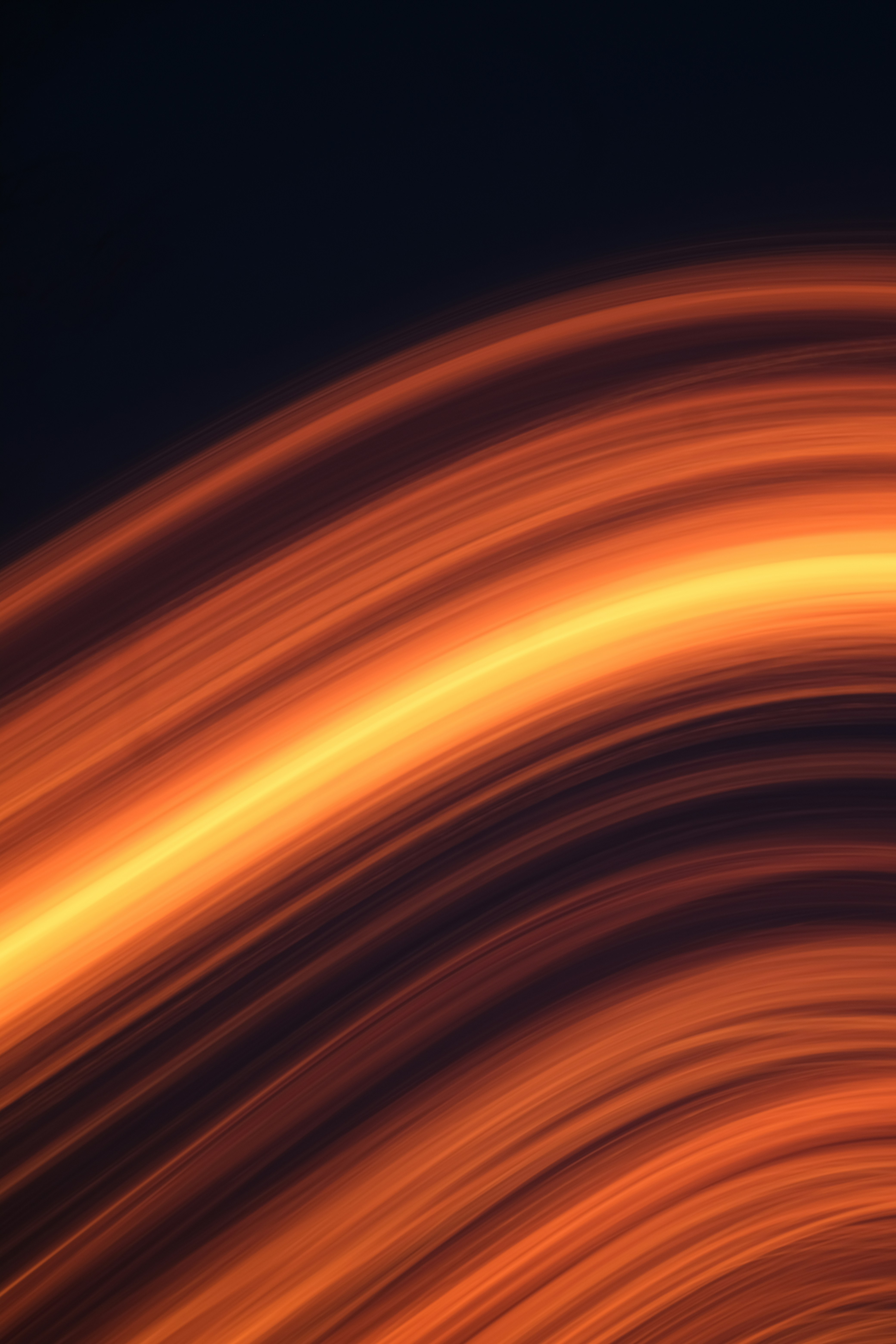 Abstract glowing orange and yellow light trails