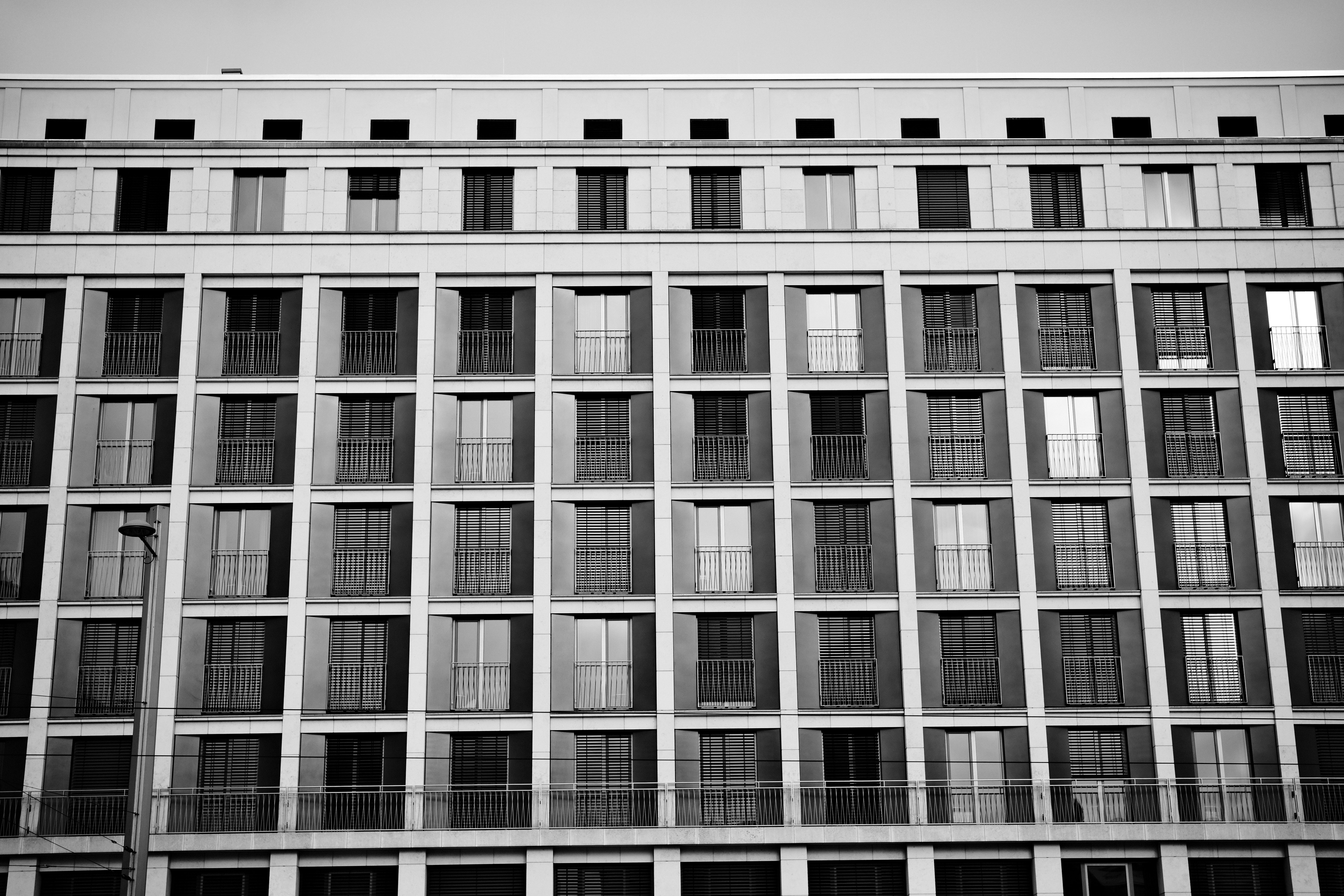 Modern building facade with repeating windows and balconies