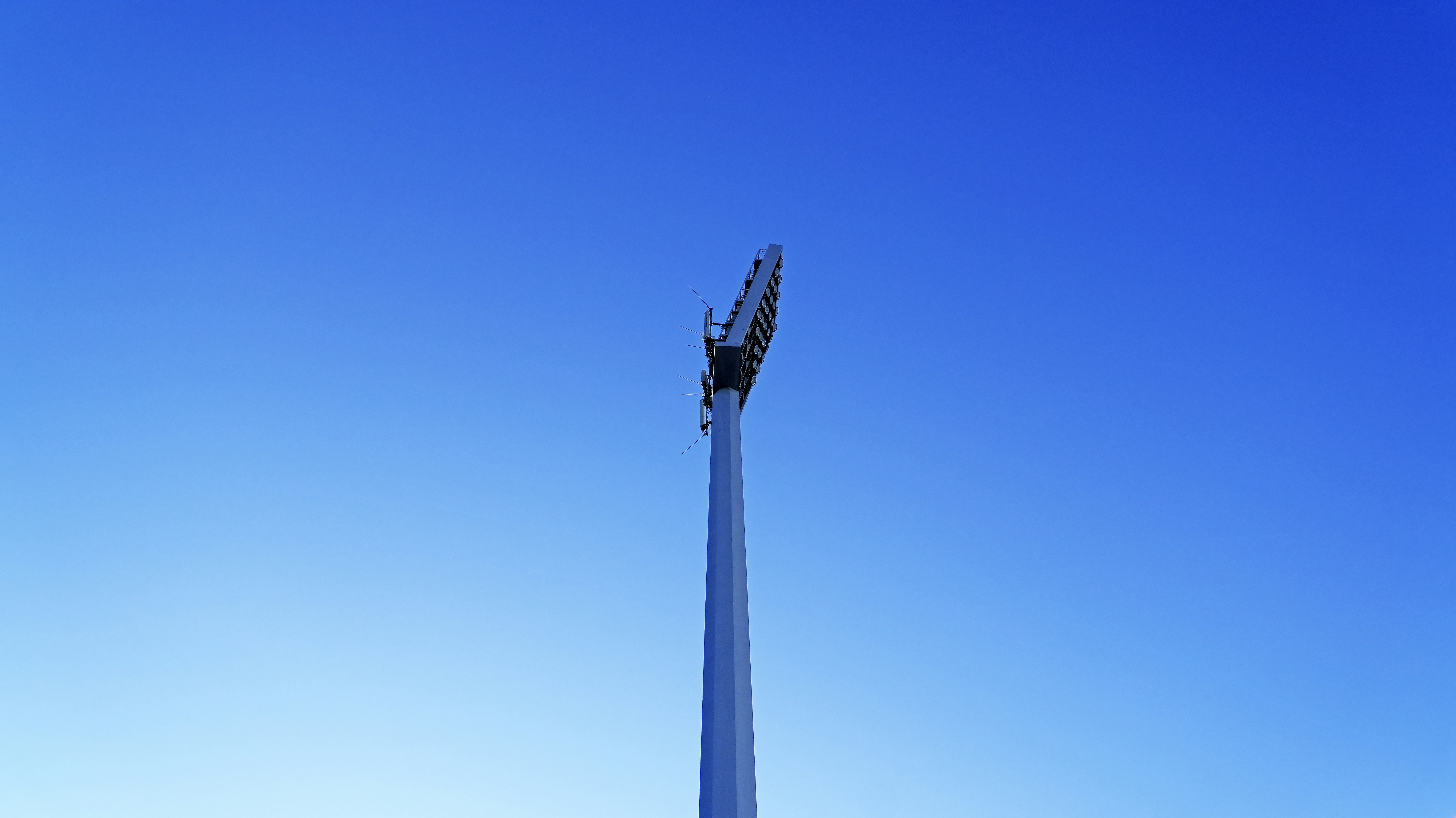 Tall light pole against a clear blue sky