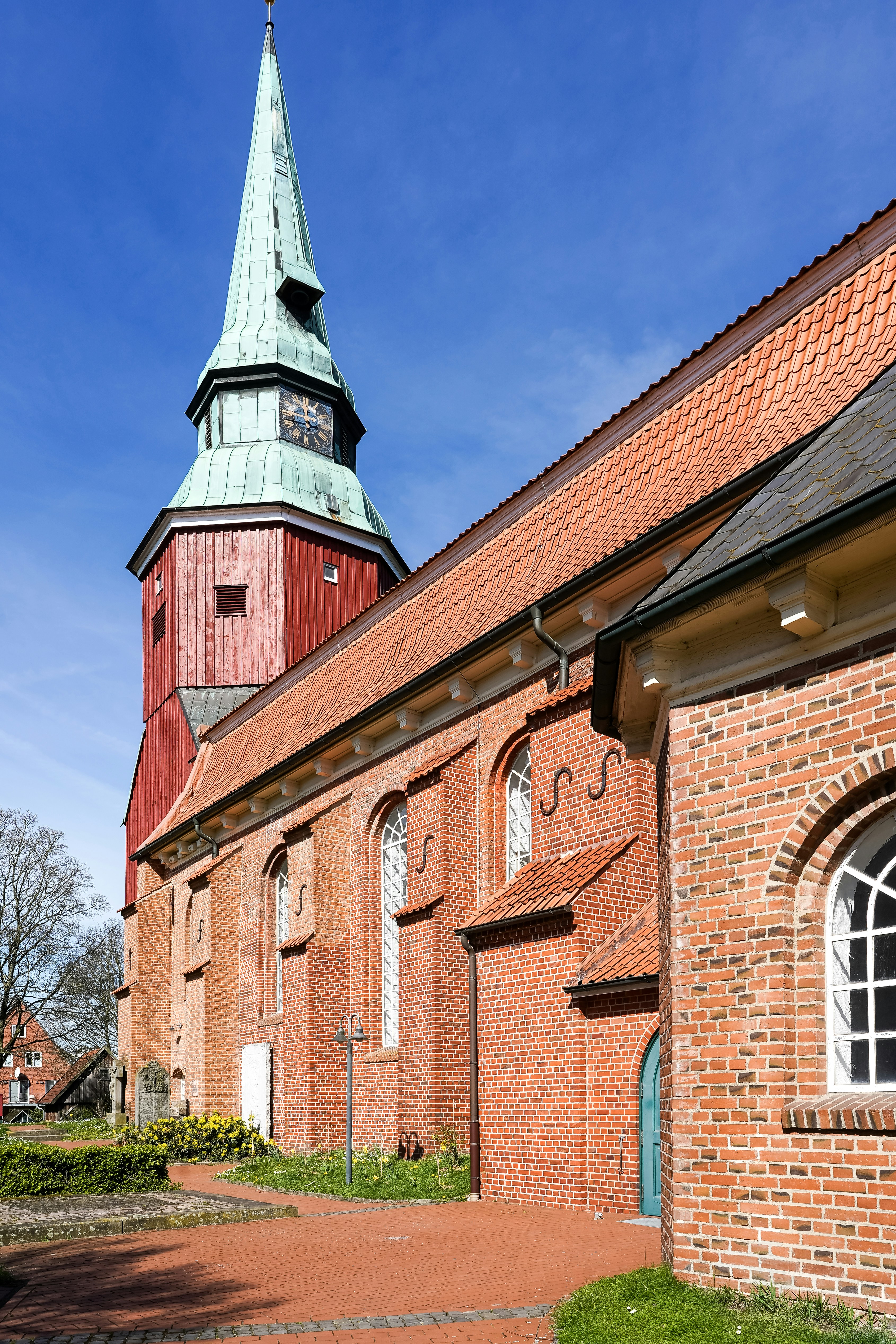 A historic brick church with a tall steeple