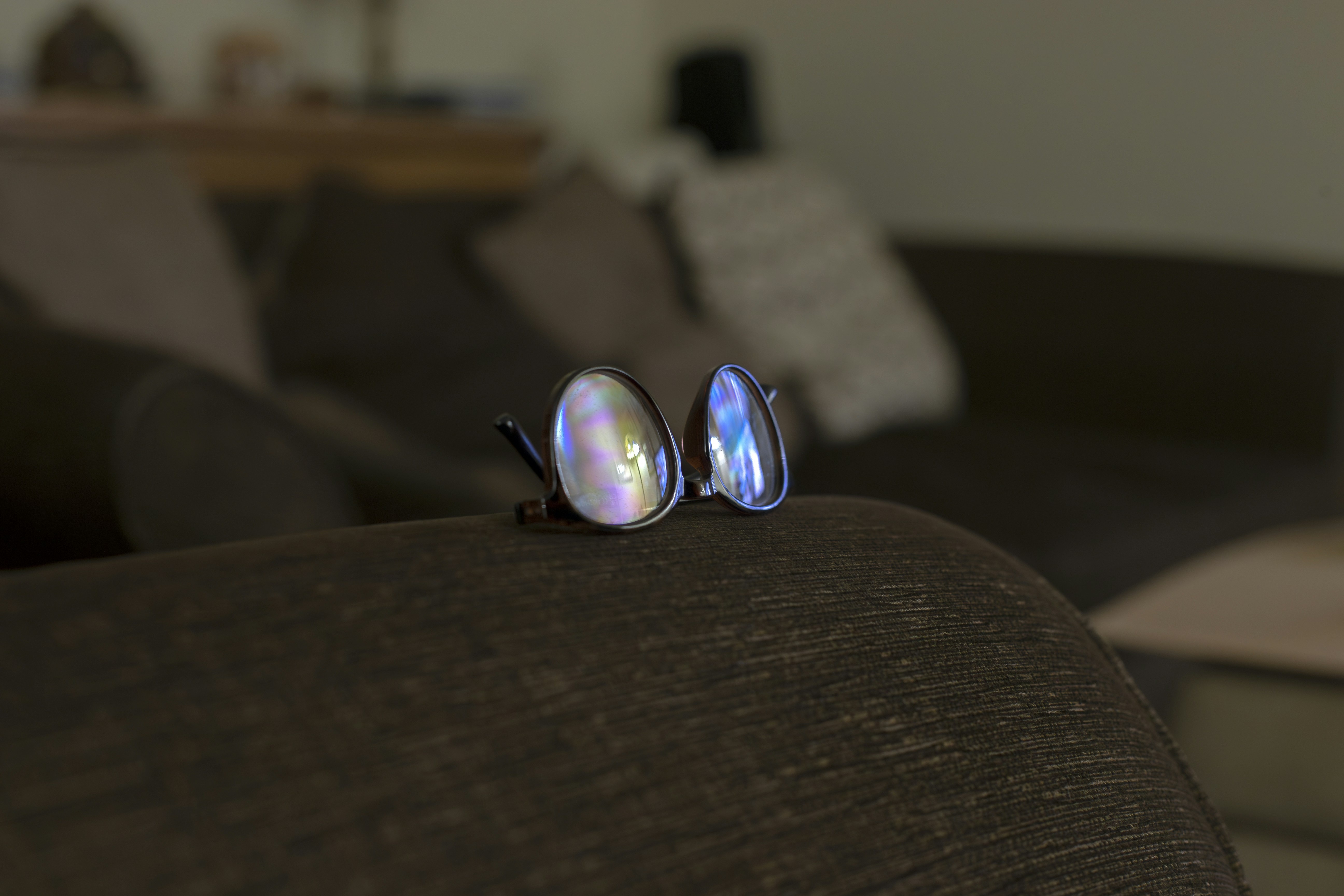 Two iridescent gemstone rings on a couch