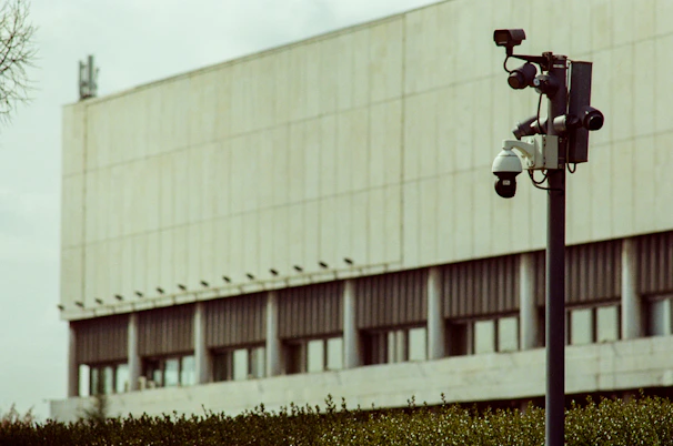 Security cameras mounted on a pole outside building