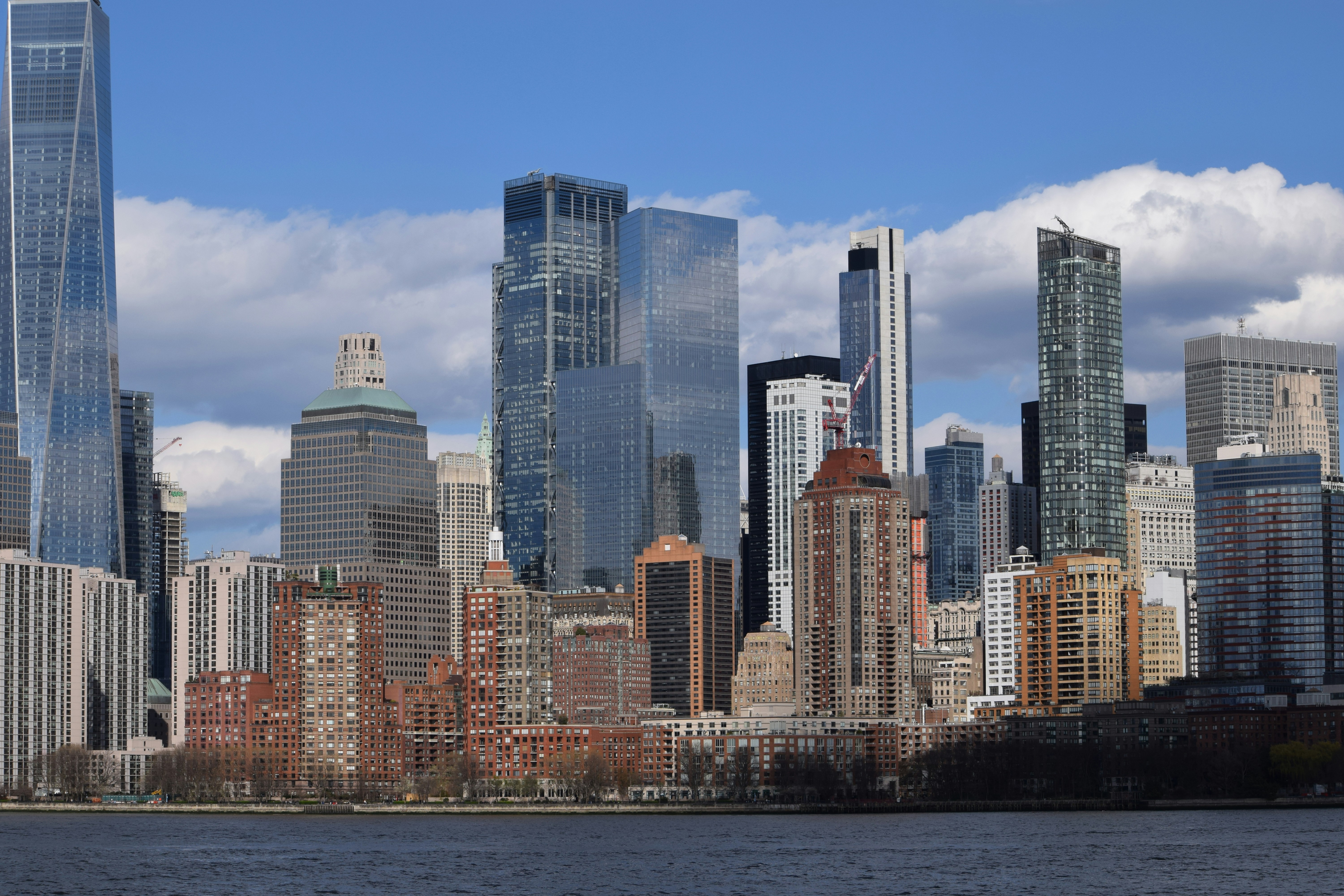 Modern skyscrapers rise above a body of water.