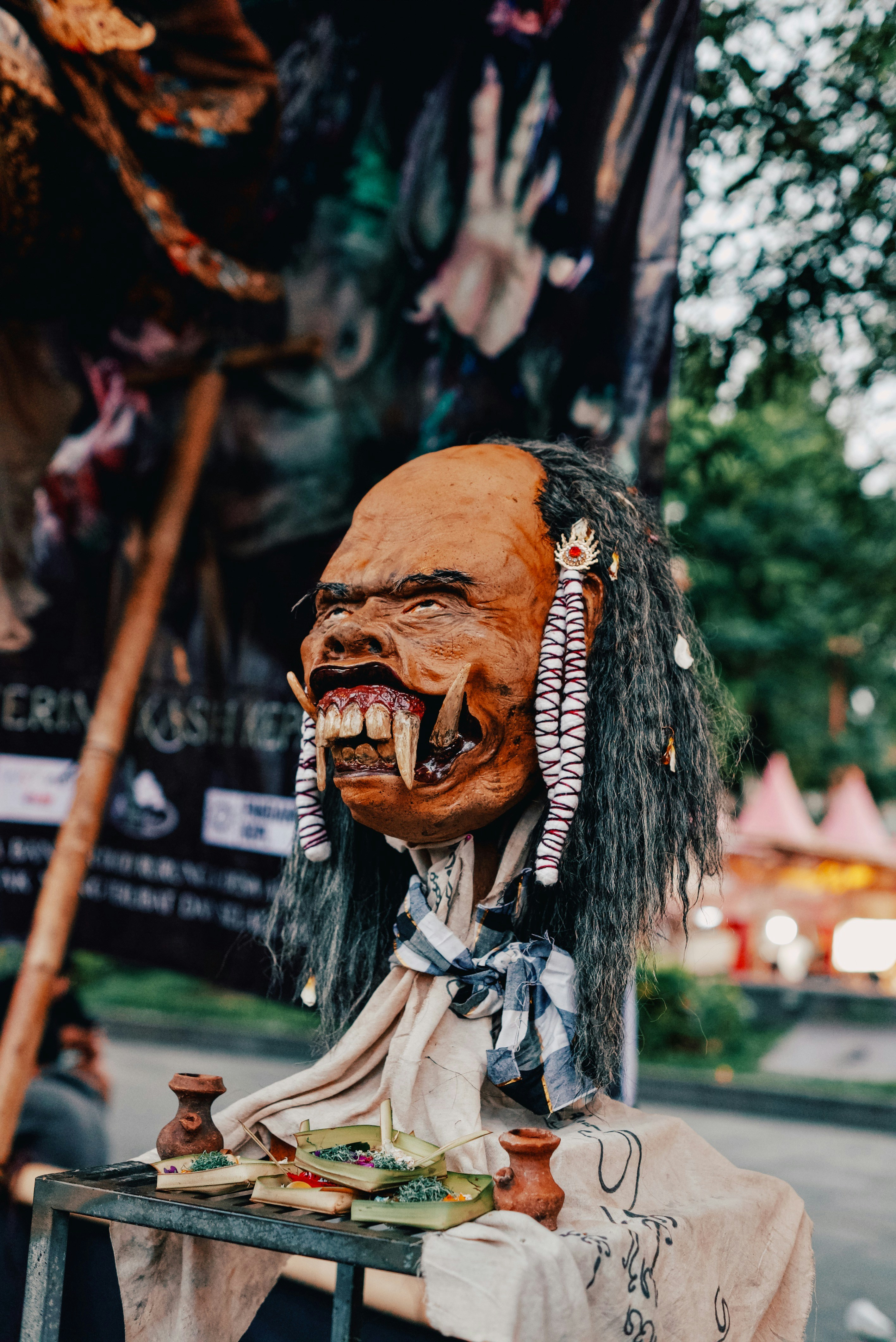 A frightening mask with sharp teeth and long hair.