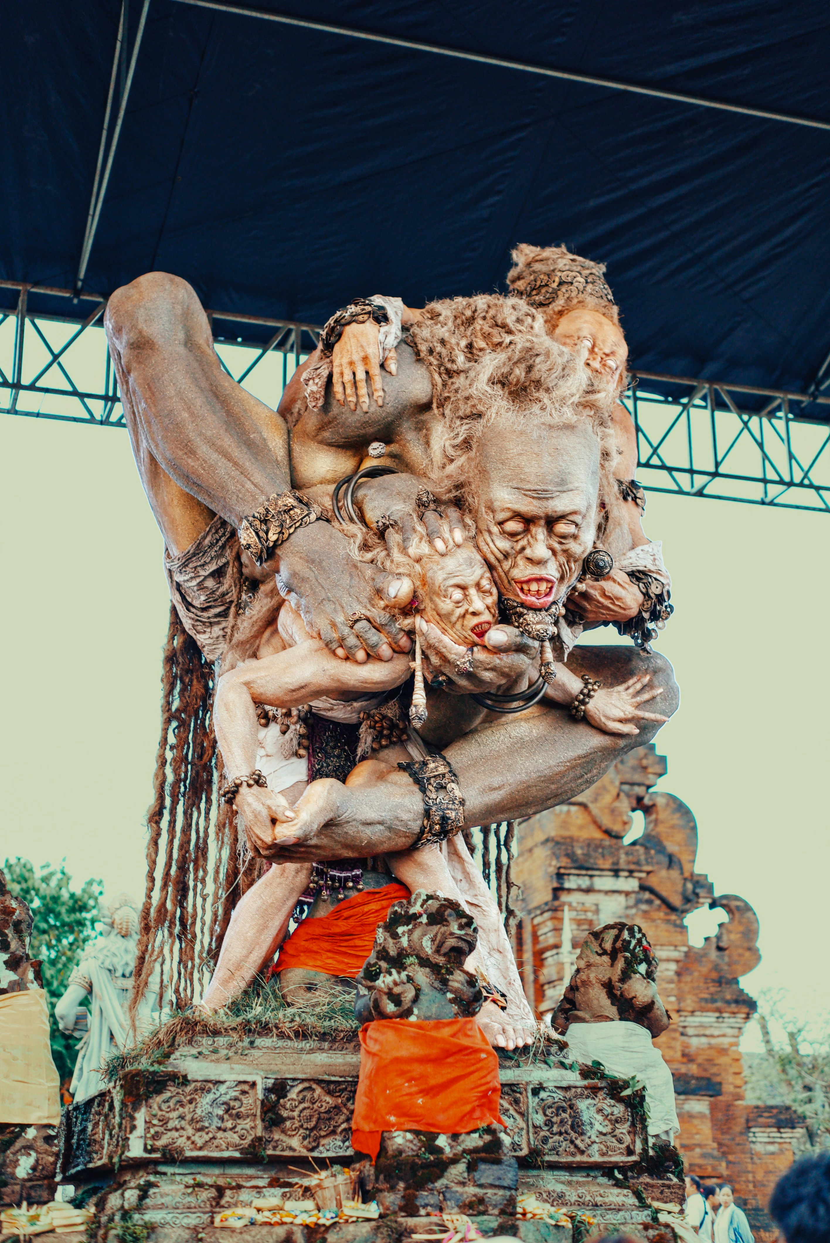A large, intricate sculpture of figures in a chaotic embrace.