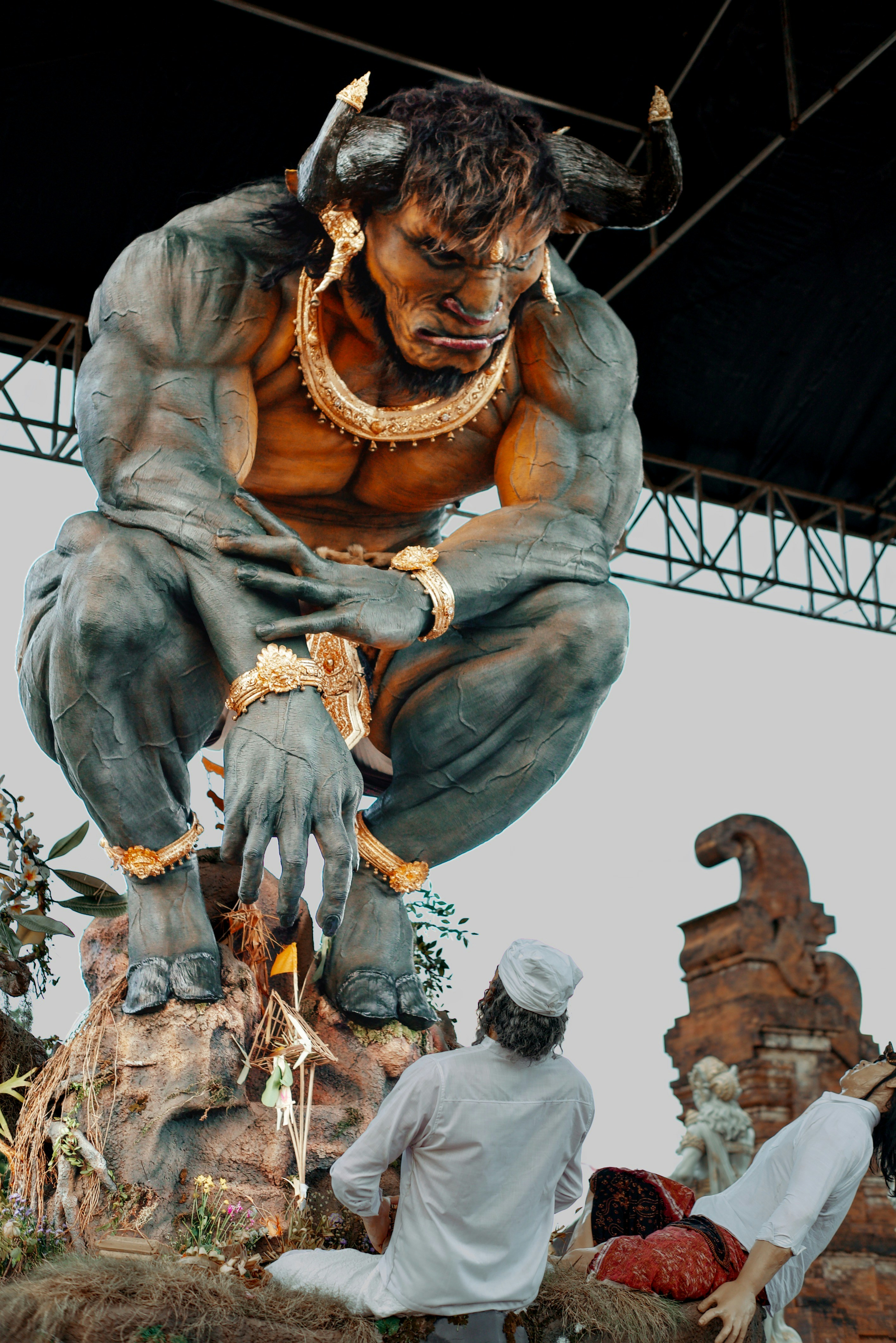 Giant mythical bull creature with people below