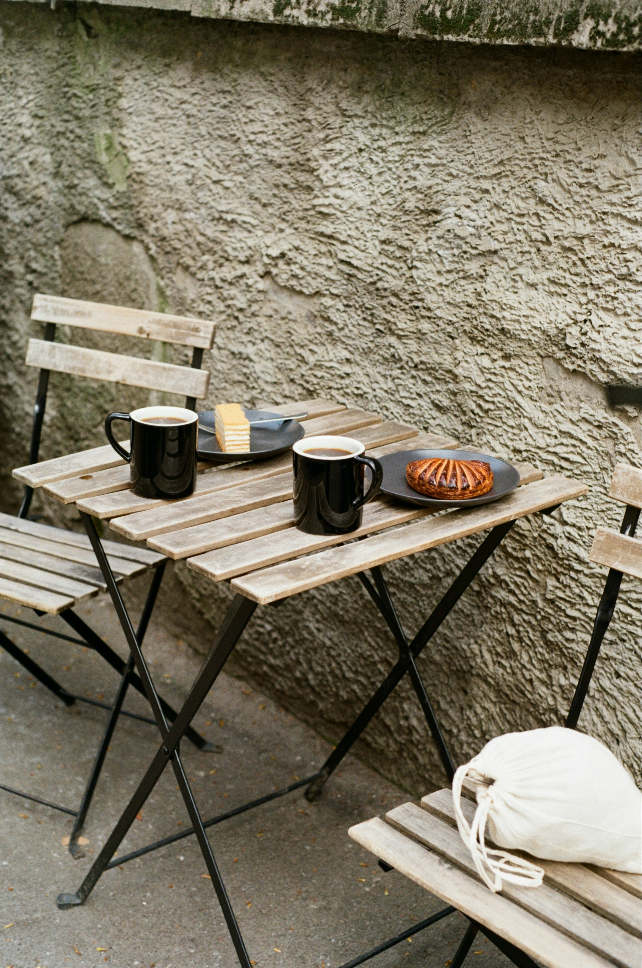 Two cups of coffee and pastries on a table